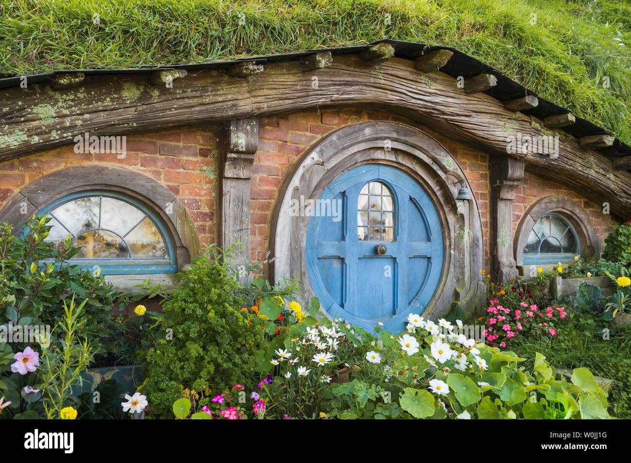 Hobbit Cave with Blue Door, Hobbiton in the Shire, location for Lord of the Rings and The Hobbit Matamata, Waikato, North Island, New Zealand Stock Photo