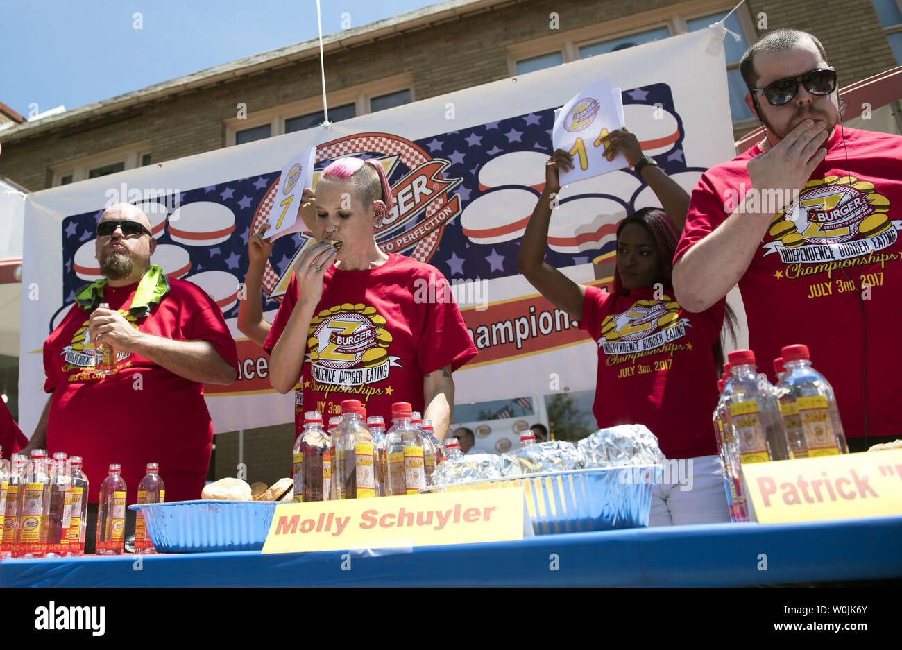 Molly Schuyler (C), Patrick 'Deep Dish' Bettletti (R) and Bob 'Notorious B.O.B. Schoudt  compete in the Z-Burger 8th Annual Independence Burger Eating Championship, in Washington D.C. on July 3, 2017. Schuyler won this year's contest eating 21 burgers in 10 minutes. Photo by Kevin Dietsch/UPI Stock Photo