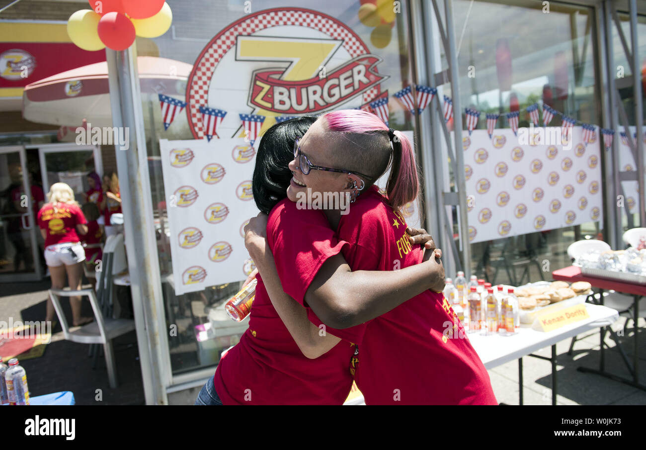 Molly Schuyler (R), hugs Quanique Beasley after the Z-Burger 8th Annual Independence Burger Eating Championship, in Washington D.C. on July 3, 2017. Schuyler won this year's contest eating 21 burgers in 10 minutes. Photo by Kevin Dietsch/UPI Stock Photo