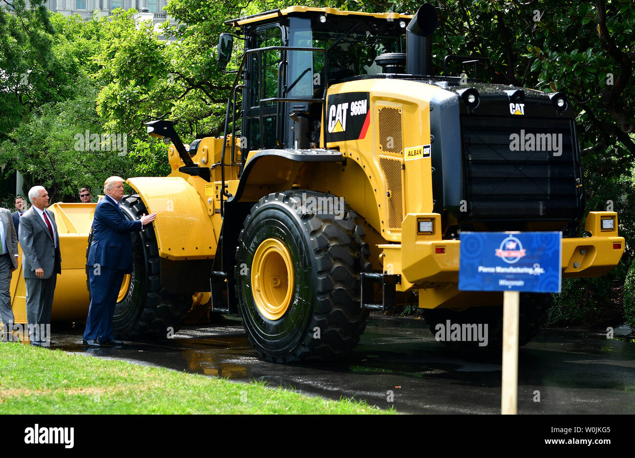 President Donald Trump (R) and Vice President Mike Pence inspect a Caterpillar front end loader during a Made in America product showcase, on the South Lawn of the White House in Washington, D.C. on July 17, 2017. Trump hosted manufacturers and corporations for all 50 states to highlight American made products. Photo by Kevin Dietsch/UPI Stock Photo