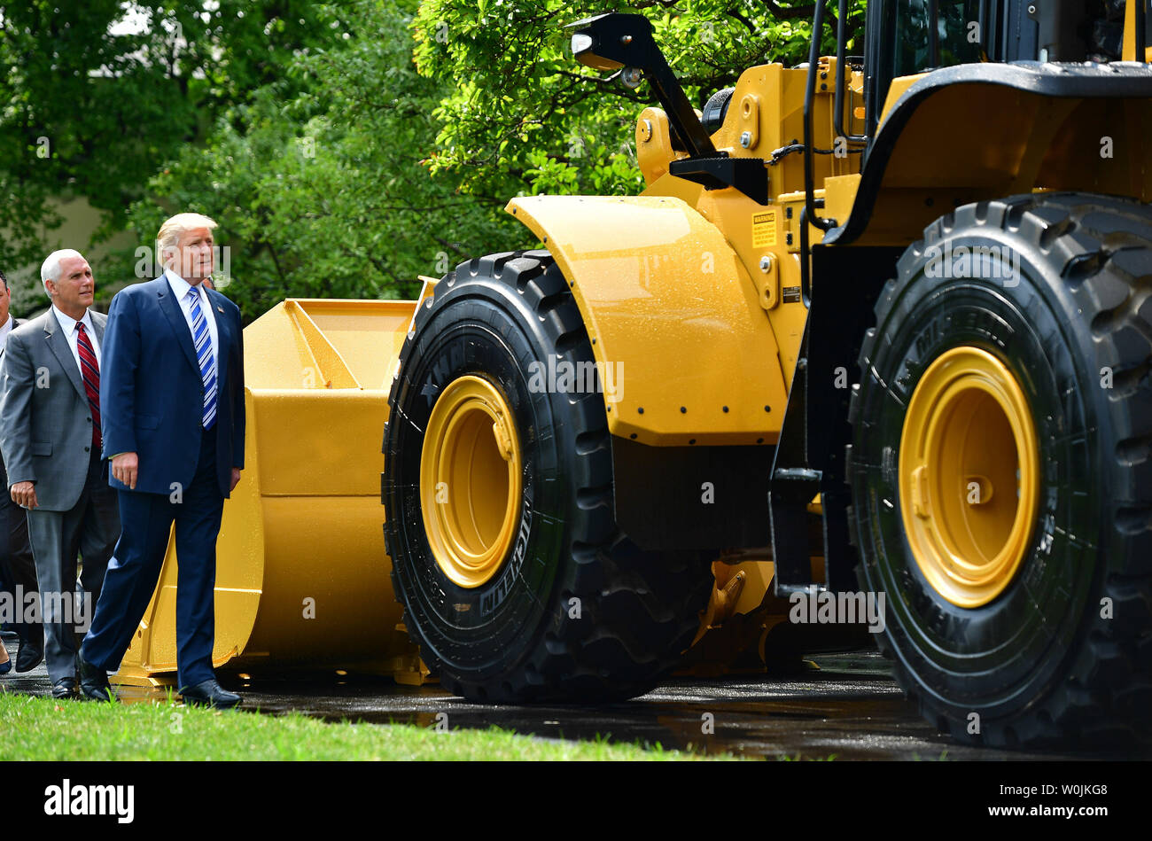 President Donald Trump (R) and Vice President Mike Pence inspect a Caterpillar front end loader during a Made in America product showcase, on the South Lawn of the White House in Washington, D.C. on July 17, 2017. Trump hosted manufacturers and corporations for all 50 states to highlight American made products. Photo by Kevin Dietsch/UPI Stock Photo