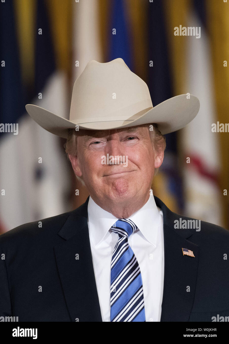 President Donald Trump puts on a Stetson cowboy hat during a Made in  America product showcase on Made in America day at the White House in  Washington, D.C. on July 17, 2017.