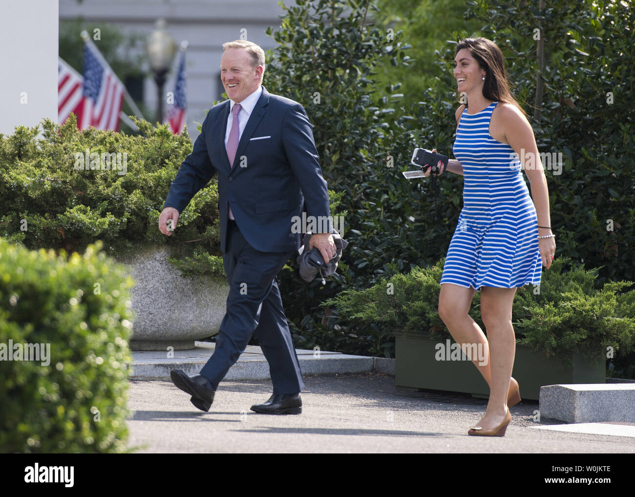 Outgoing White House Press Secretary Sean Spicer walks with aid Vanessa Morrone as they return to the White House in Washington, D.C. on July 21, 2017. Spicer announced his resignation earlier today and will be replaced by Principal Deputy White House Press Secretary Sarah Huckabee Sanders. Photo by Kevin Dietsch/UPI Stock Photo