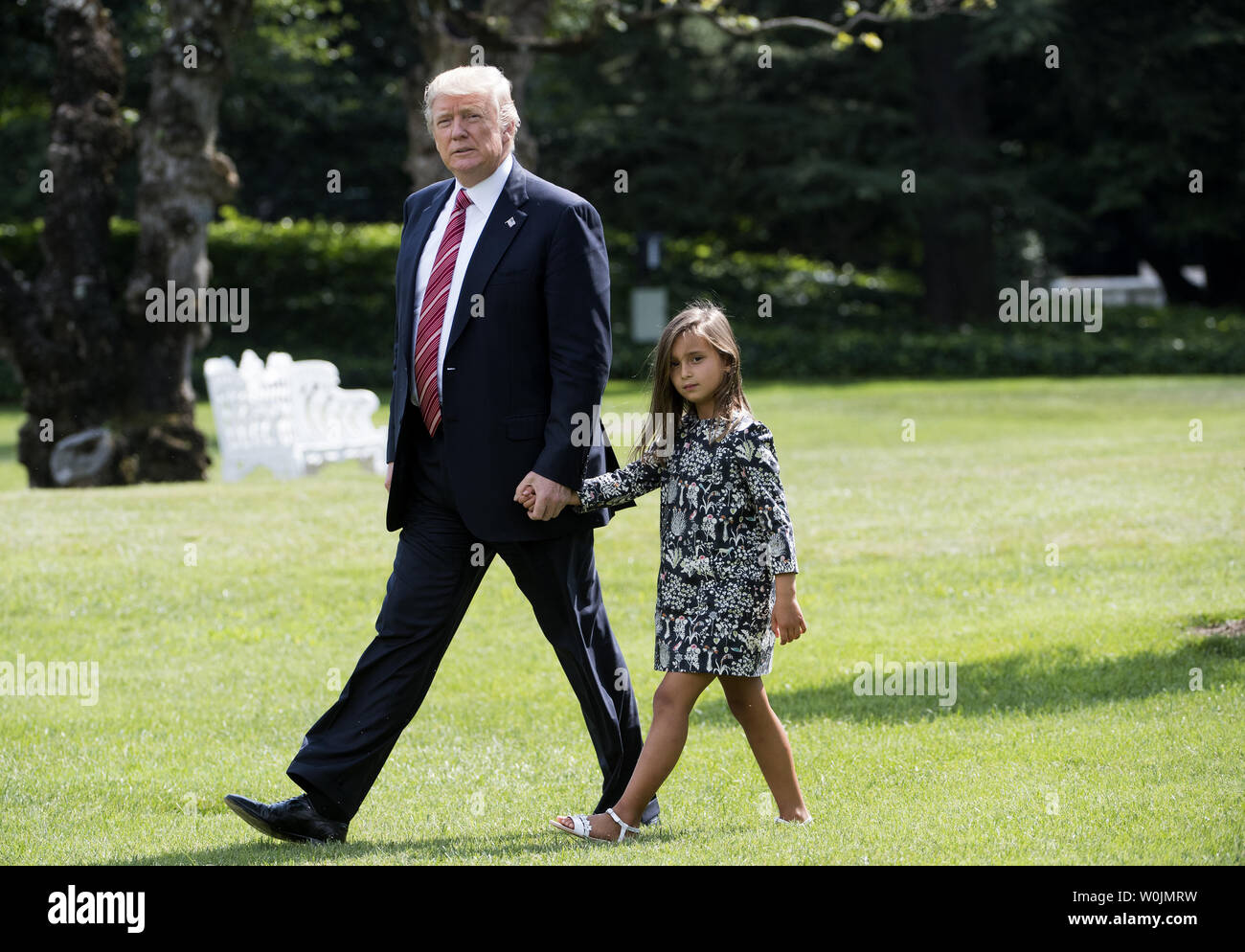 President Donald Trump holds hands with his granddaughter Arabella Rose Kushner as they departs