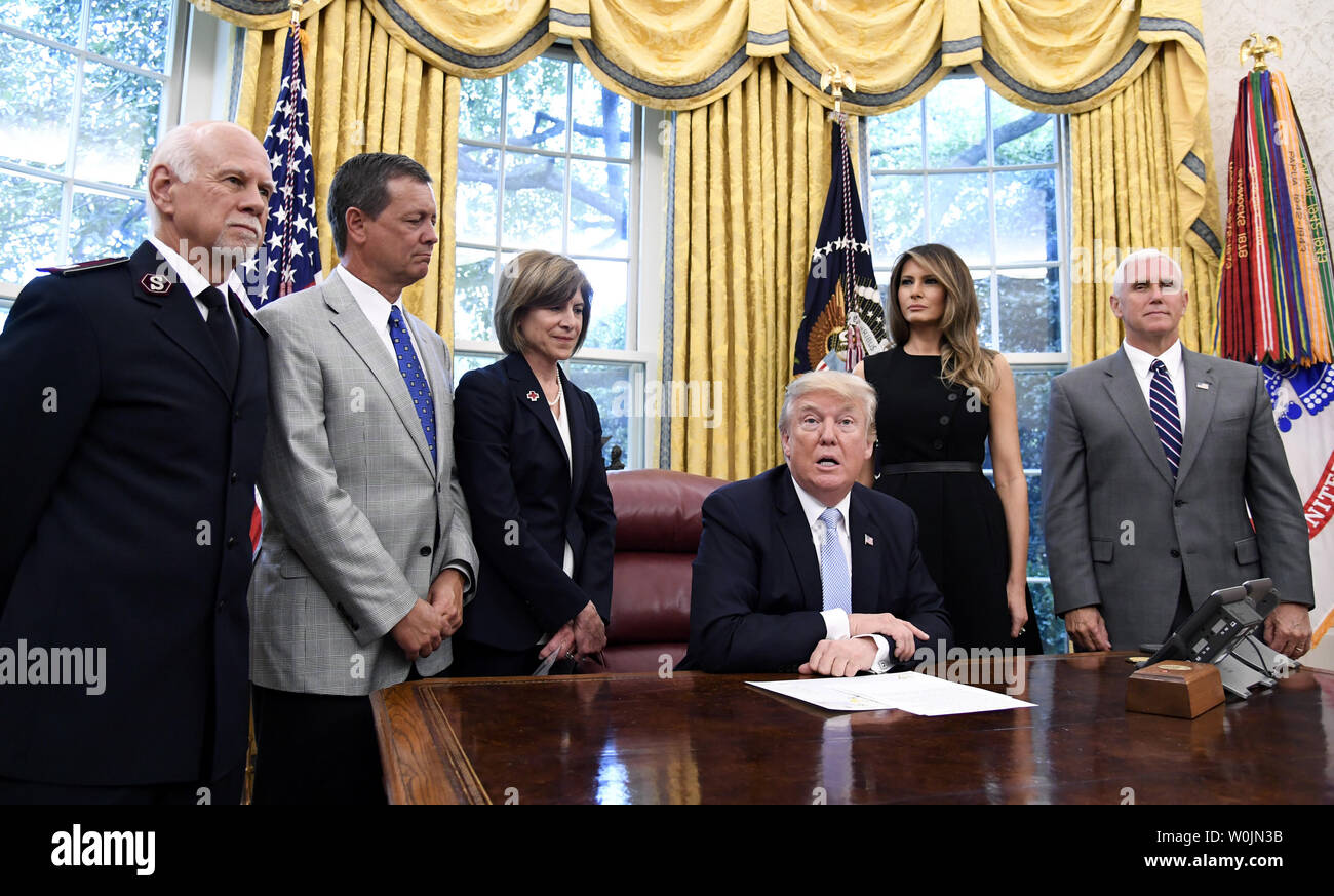 President Donald Trump makes remarks to the press about Hurricane Harvey relief efforts as (L-R) Salvation Army National Commissioner David Hudson, Southern Baptist Disaster Relief Fund President Kevin Ezell, Red Cross President Gail J. McGovern, First Lady Melania Trump and Vice President Mike Pence listen, in the Oval Office of the White House, September 1, 2017, in Washington, DC. Trump thanked the organizations for their contributions during the disaster in Texas.            Photo by Mike Theiler/UPI Stock Photo