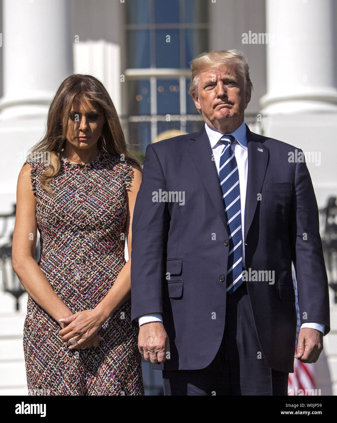 President Donald Trump and First Lady Melania Trump participate in a moment  of silence for the victims of Sunday's mass shootings in Las Vegas, at the  White House in Washington, D.C. on