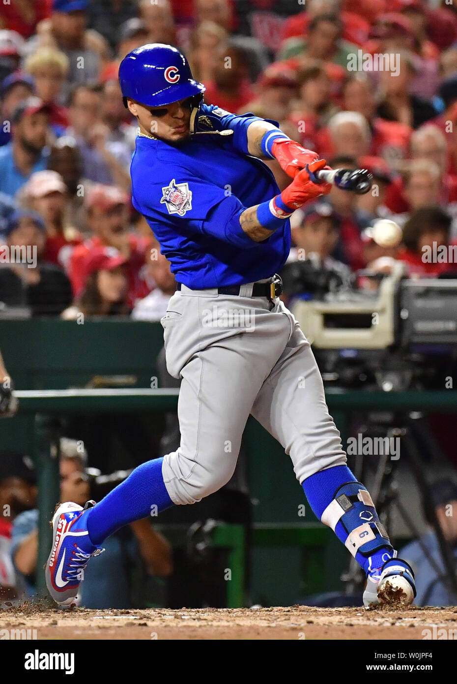 Chicago Cubs Javier Baez hits a ball flubbed by Washington