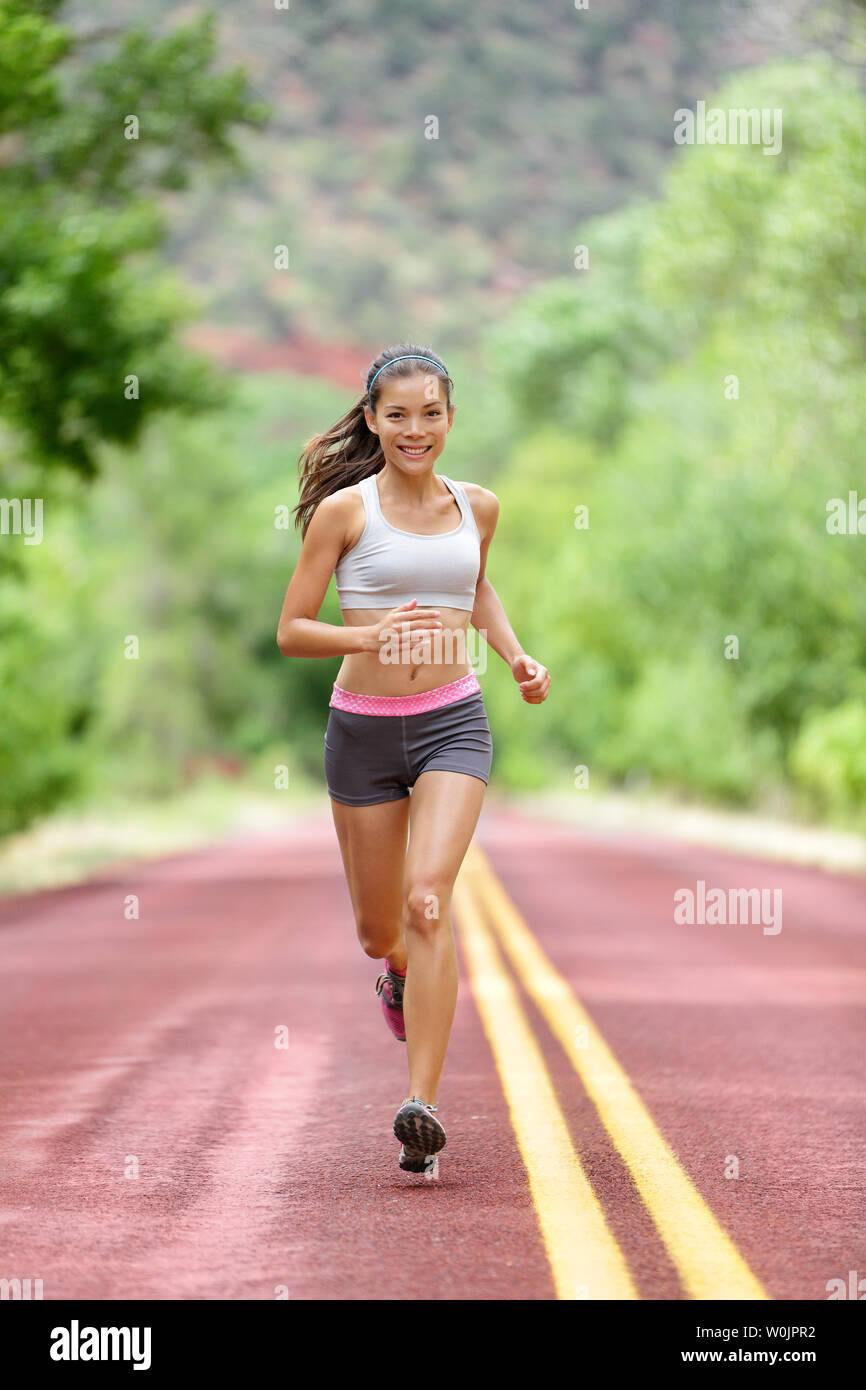 Runner woman running training living healthy fitness sport lifestyle.  Active female athlete jogging outdoors happy with aspirations. Beautiful  mixed race Asian Caucasian girl in full body length Stock Photo - Alamy