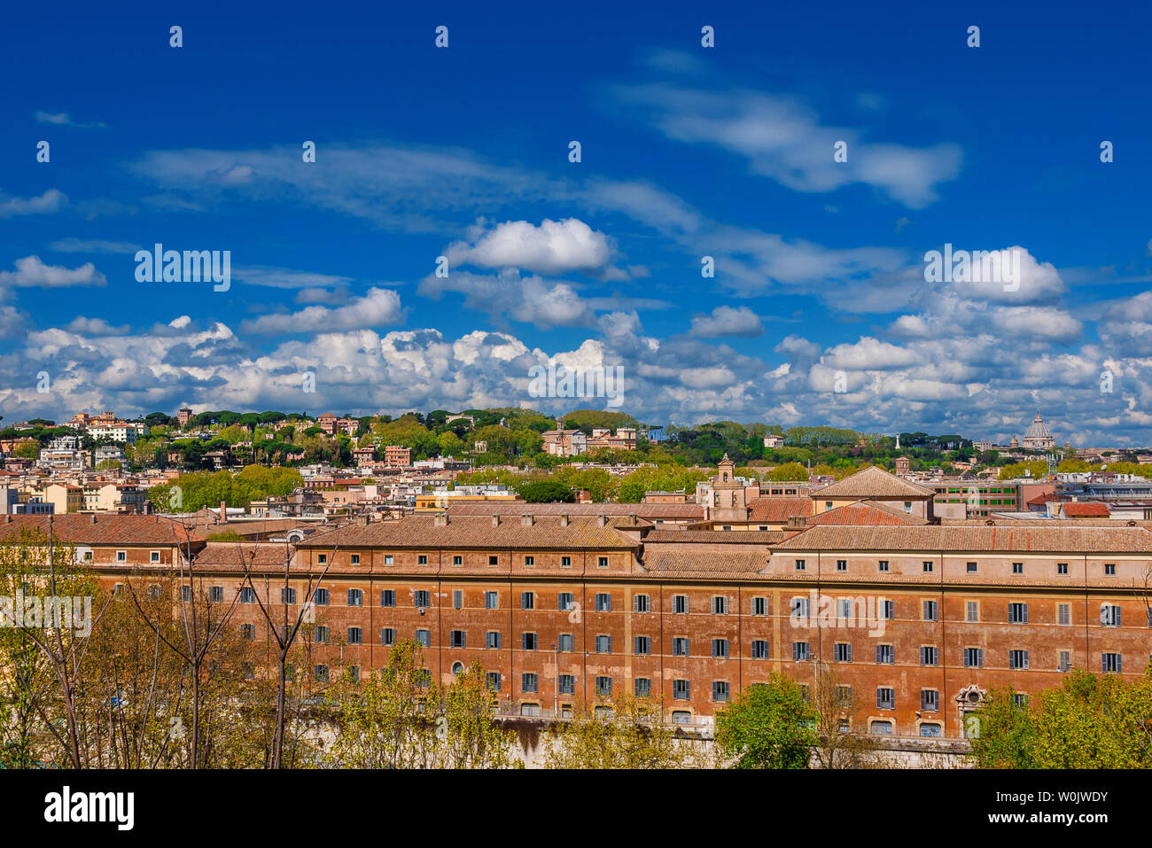 Rome historic center old skyline above Trastevere with old churches, belltowers, domes and clouds, seen from Aventine Hill Stock Photo