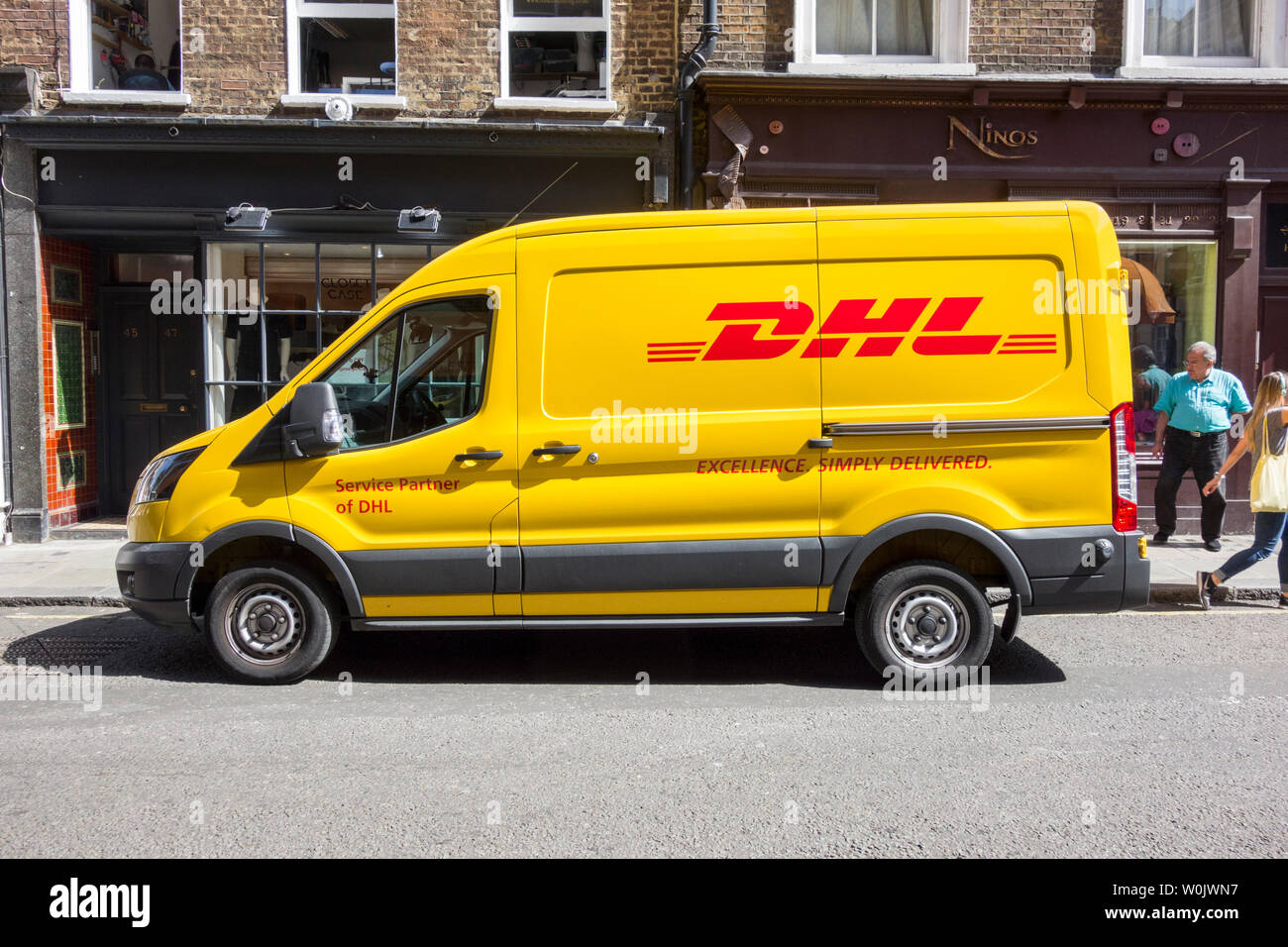 A DHL delivery van parked on a street in Soho, central London, UK Stock Photo