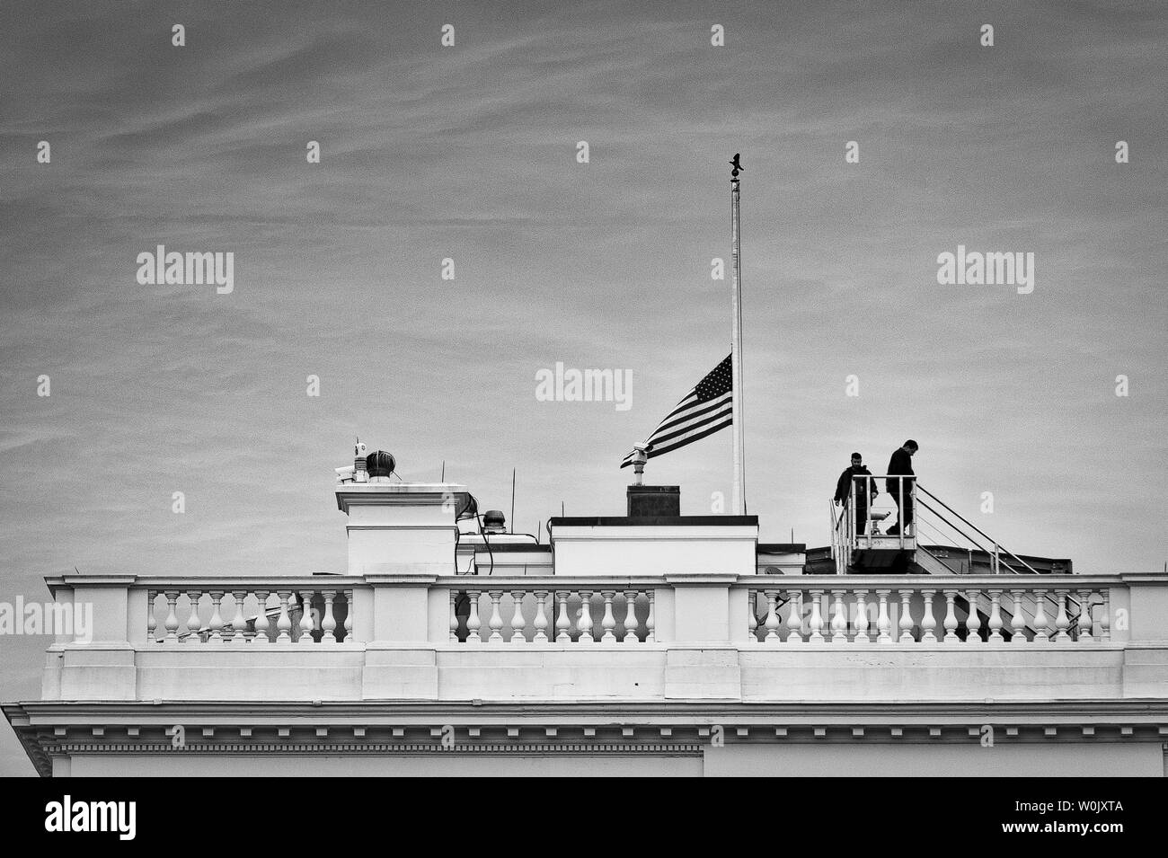 Staff members leave the roof of the White House after lowering the flag to half staff to honor the victims of the recent high school mass shooting in Florida on February 15, 2018 in Washington, DC. The suspect, Nikolas Cruz, 19, gunned down students and teachers at Marjory Stoneman Douglas High School in Parkland, Fla., killing 17 and wounding many more..        Photo by Pete Marovich/UPI Stock Photo