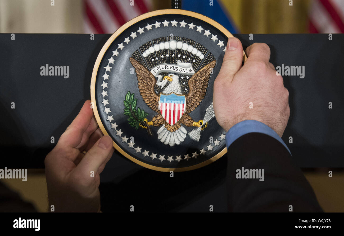 An aid places the Presidential Seal on the podium prior to a joint press conference between President Donald J. Trump and Prime Minister Stefan Lofven of Sweden, at the White House in Washington, D.C. on March 6, 2018. Photo by Kevin Dietsch/UPI Stock Photo