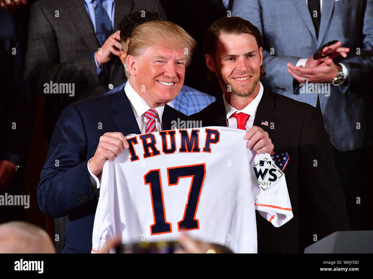 President Donald Trump (L) receives a custom jersey from Houston Astros  outfielder Josh Reddick as Trump welcomes the 2017 World Series Champion  Houston Astros to the White House on March 12, 2018