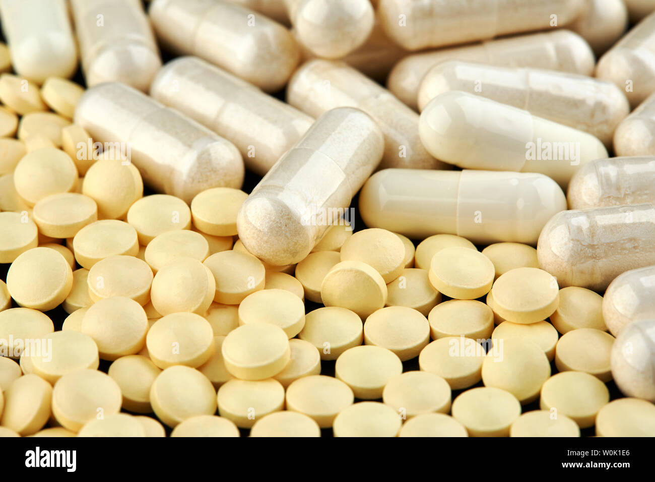 Yellow White Pill Capsule High Resolution Stock Photography and Images