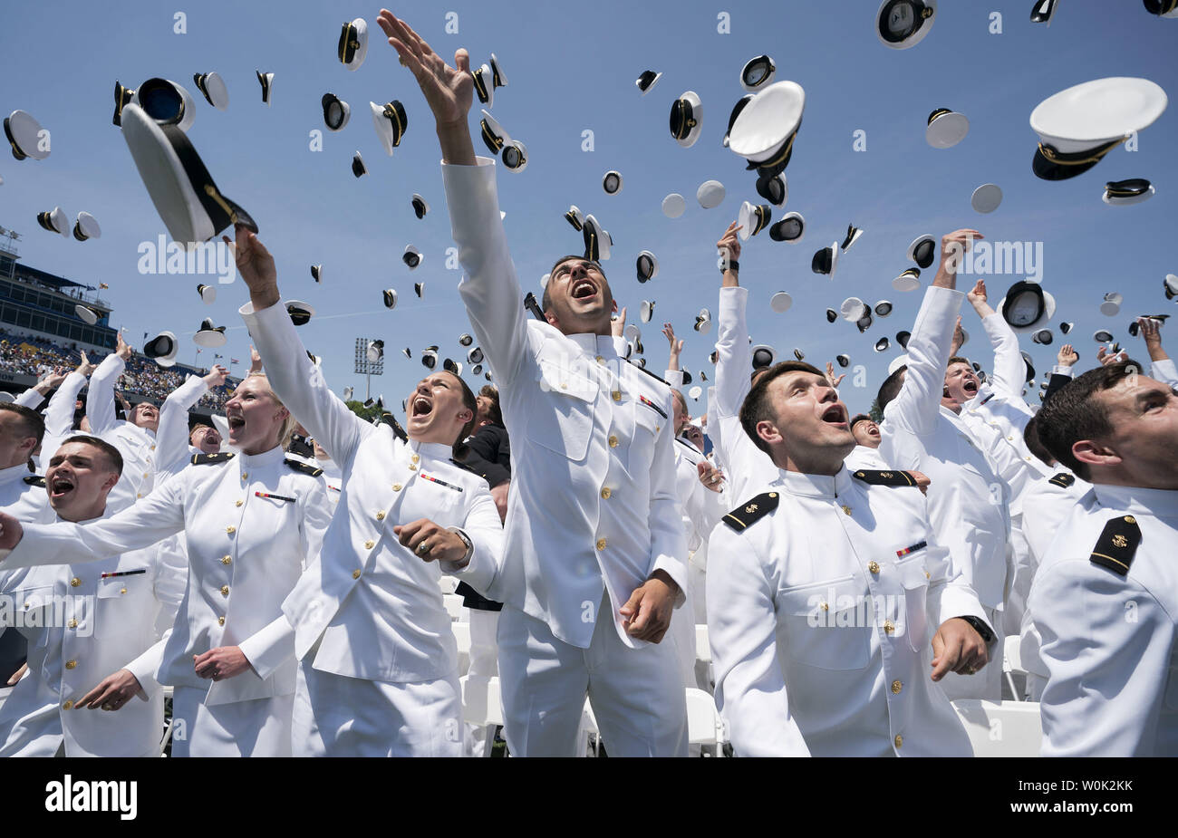 Graduating midshipmen throw their hats into the air at the conclusion