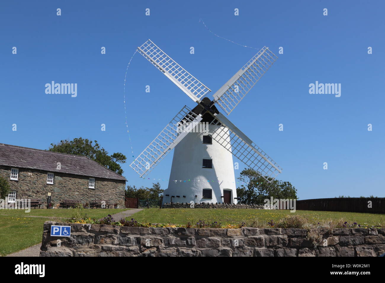 Melin Llynnon is a fully restored working windmill and café built in 1775 with iron-age roundhouses at Llanddeusant Anglesey Wales Stock Photo