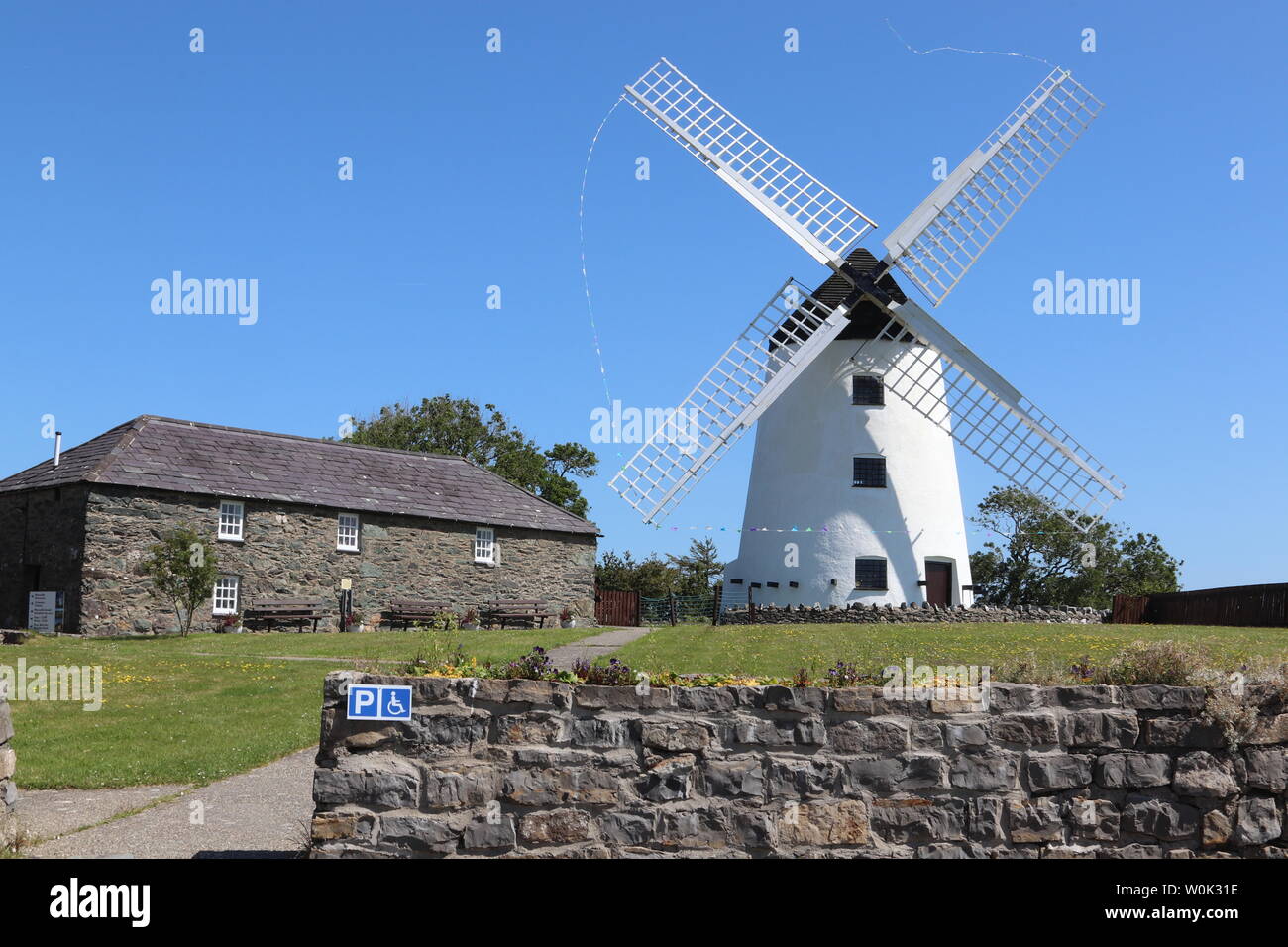 Melin Llynnon is a fully restored working windmill and café built in 1775 with iron-age roundhouses at Llanddeusant Anglesey Wales Stock Photo