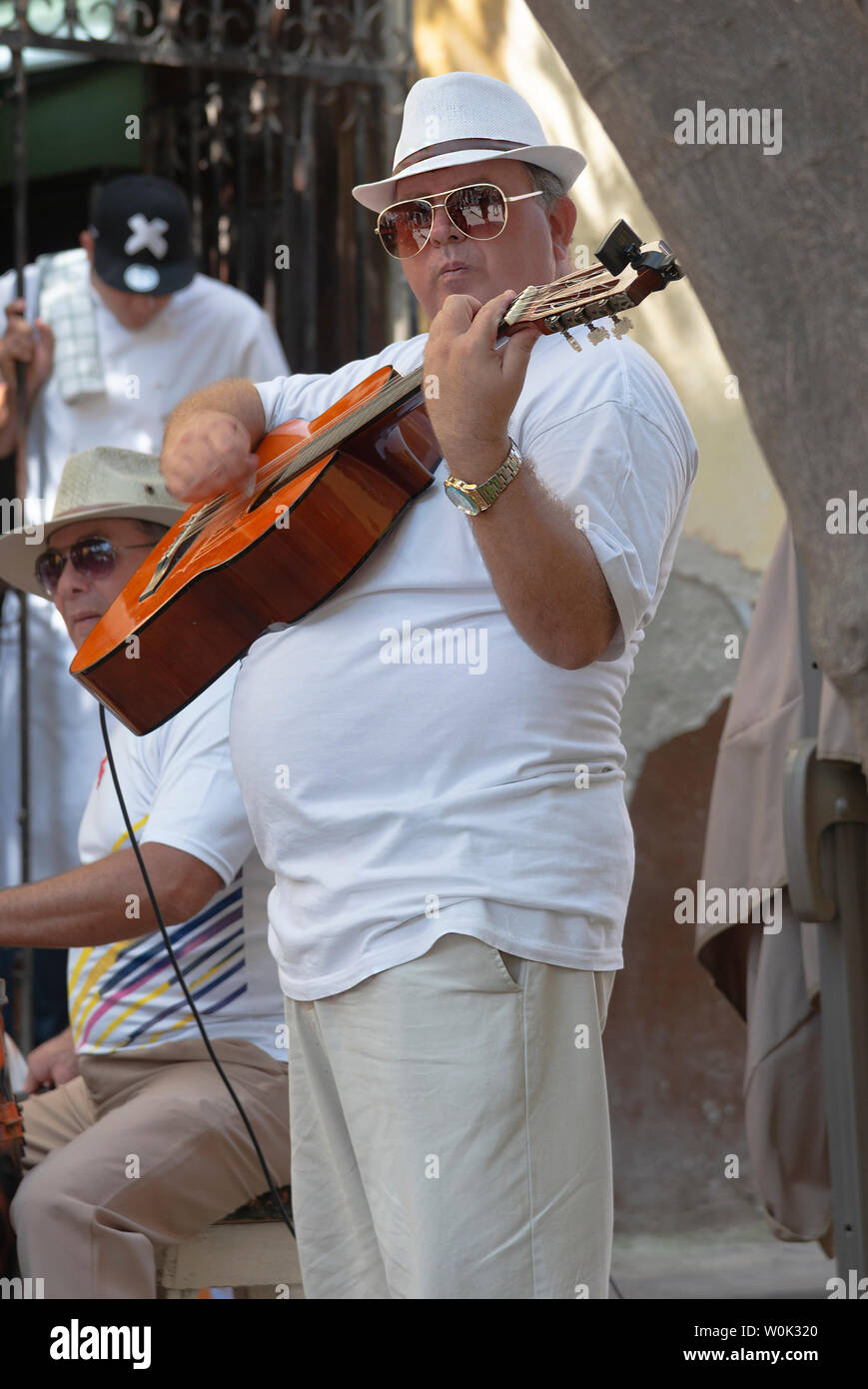 Guitarist, part of a band, plays music in a street in the Old Town, or Havana Vieja,   Havana, Cuba, Caribbean Stock Photo