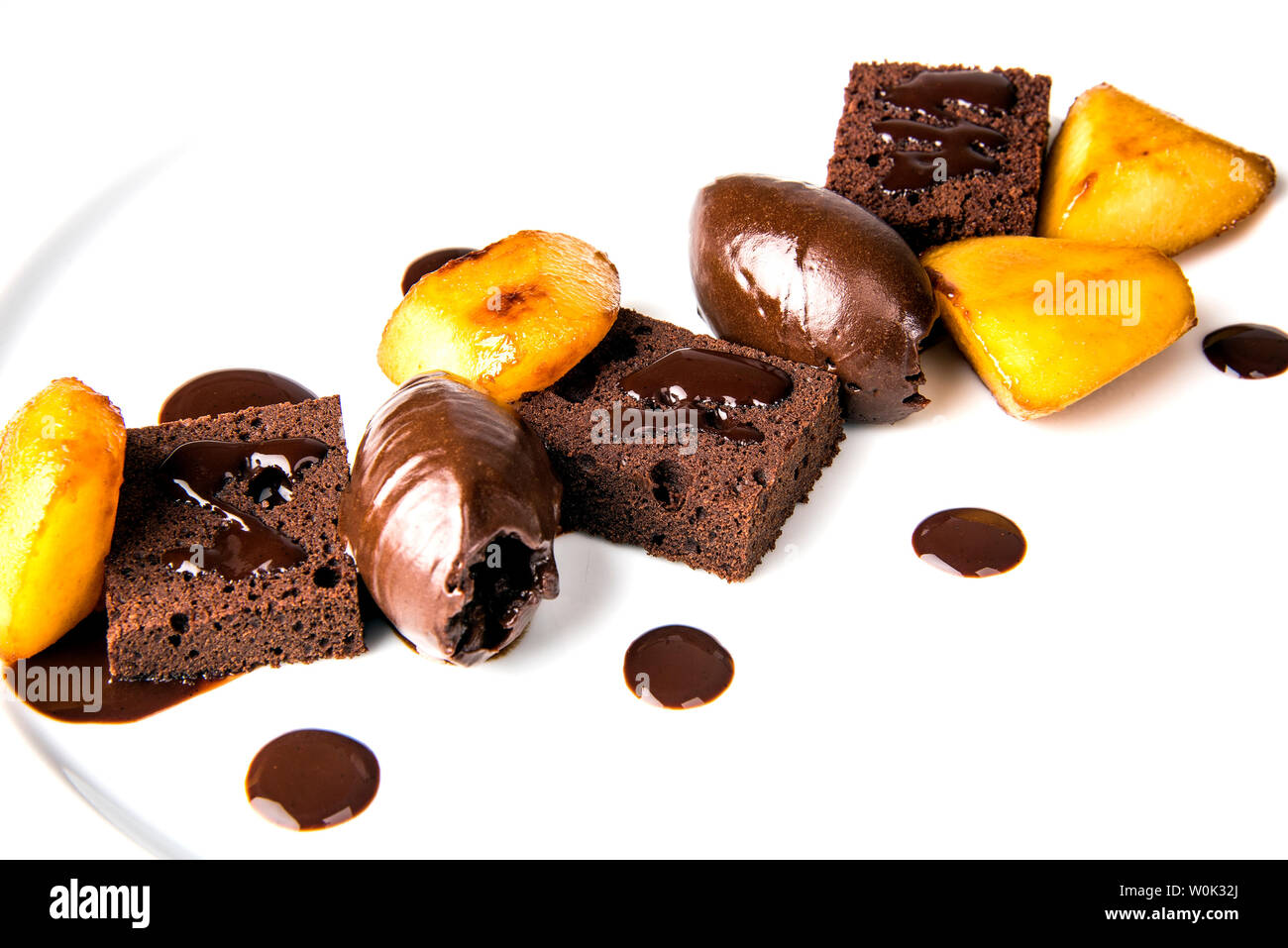 plated chocolate and pear dessert with chocolate sponge and a chocolate  sauce Stock Photo - Alamy