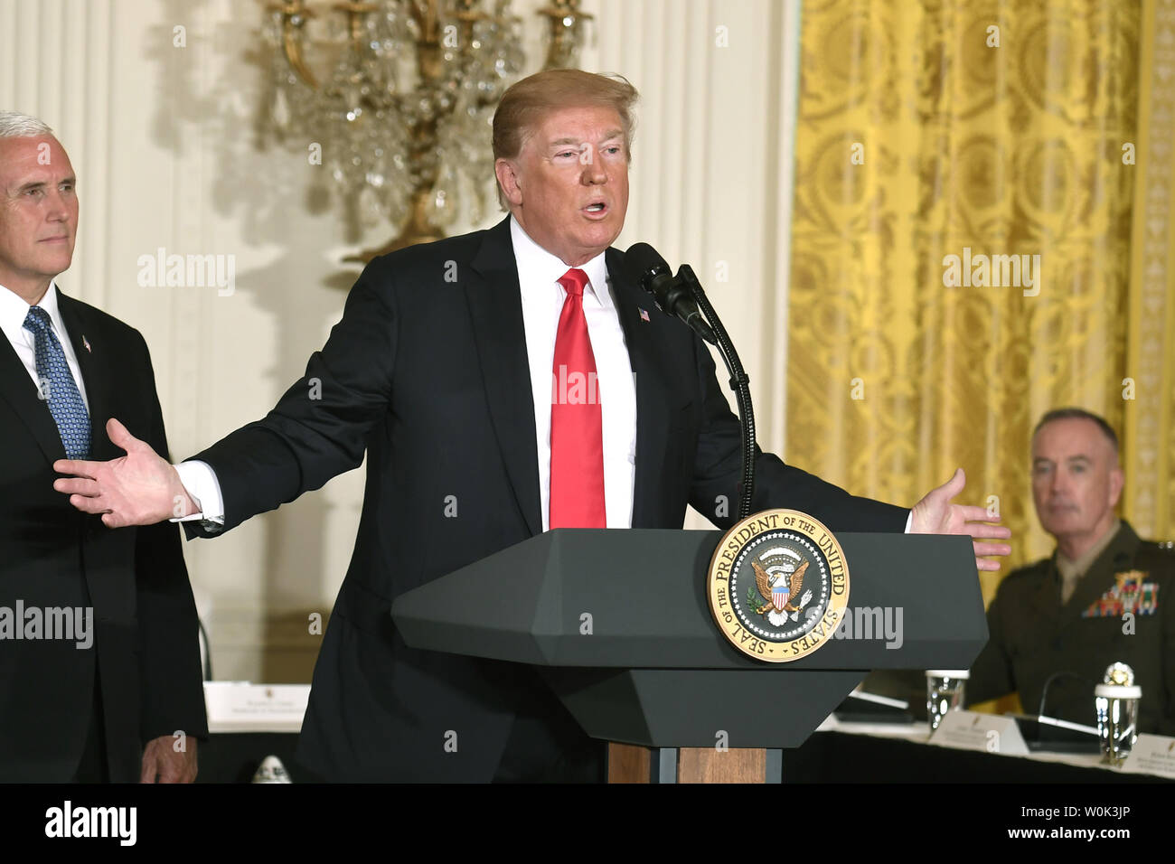 President Donald Trump makes remarks as Vice President Mike Pence (L) and Chairman of the Joint Chiefs of Staff Gen. Joseph Dunford listen, as he hosts the National Space Council in the East Room of the White House, June 18, 2018, in Washington, DC. Trump signed a directive to reform and modernize US commerical space policy.                                  Photo by Mike Theiler/UPI Stock Photo