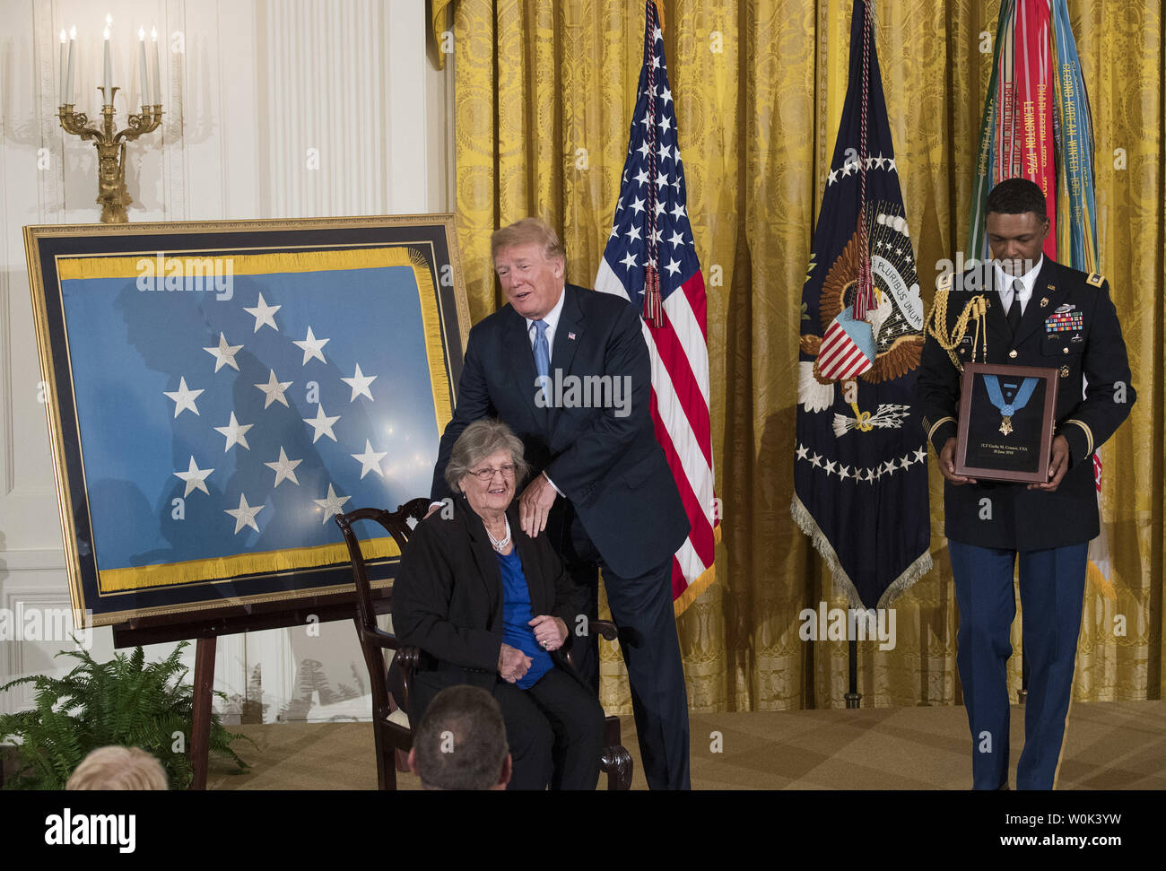 President Donald Trump embraces Pauline Lyda Wells Conner the widow of Army First Lt. Garlin M. Conner who Trump posthumously awarded the Medal of Honor, during a ceremony in the East Room at the White House in Washington, D.C. on June 26, 2018.  Conner, a native of Kentucky, is being honored for his heroic actions during combat in World War II. Conner's other awards include the Distinguished Service Cross, four Silver Star medals, a bronze star and three Purple Hearts for injuries suffered in combat.  Photo by Kevin Dietsch/UPI Stock Photo