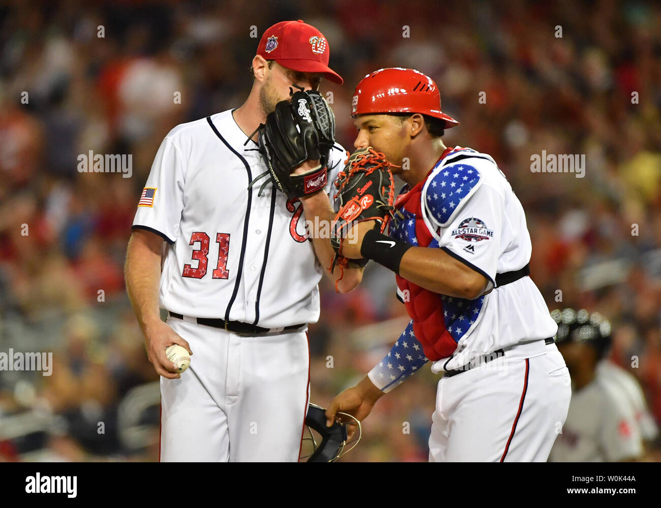 Washington Nationals starting pitcher Max Scherzer (31) talks to catcher  Pedro Severino as they meet on the mound in the sixth inning against the  Boston Red Sox at Nationals Park in Washington