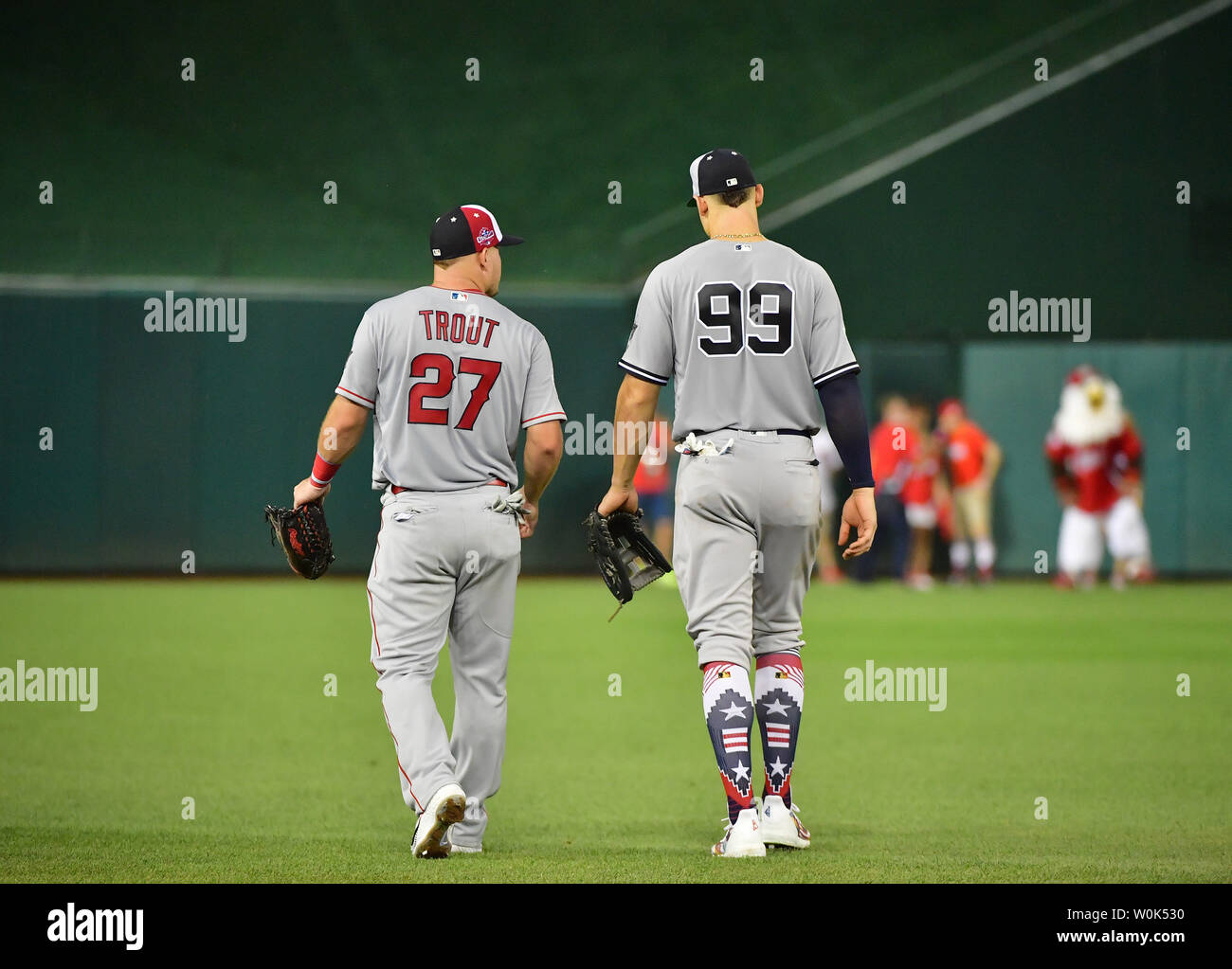 Los Angeles Angels of Anaheim's Mike Trout (27) and New York Yankees' Aaron  Judge (99) walk to the outfield during the fifth inning of the MLB All-Star  Game at Nationals Park in