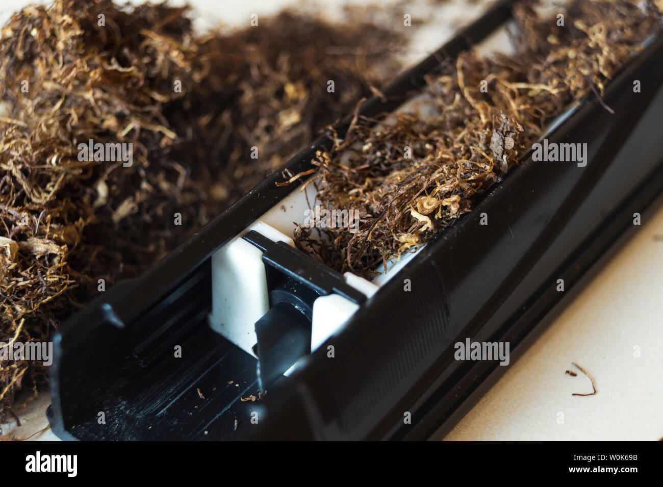 machine for stuffing cigarettes with tobacco, close up Stock Photo
