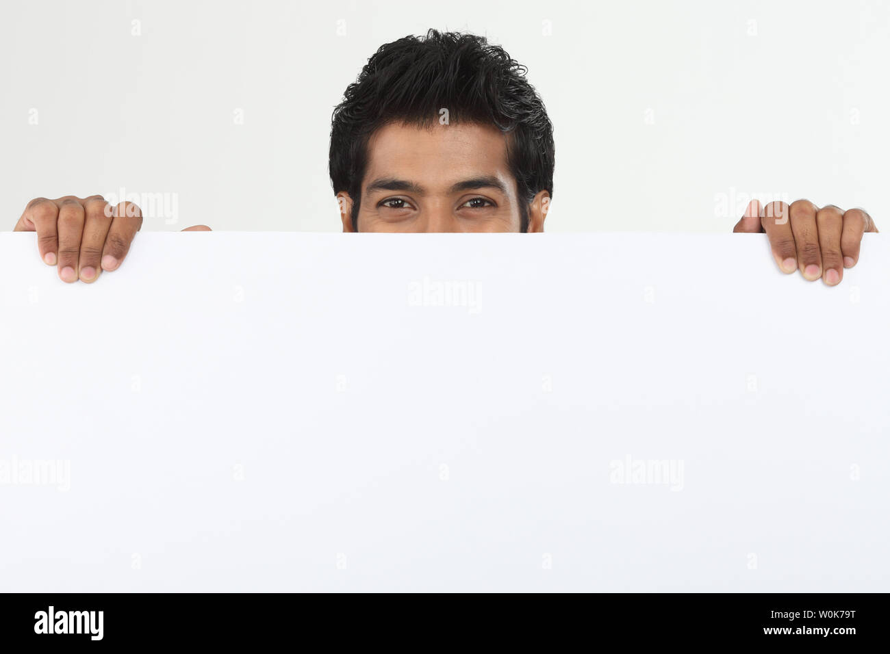 Portrait of a college student hiding behind a placard Stock Photo - Alamy