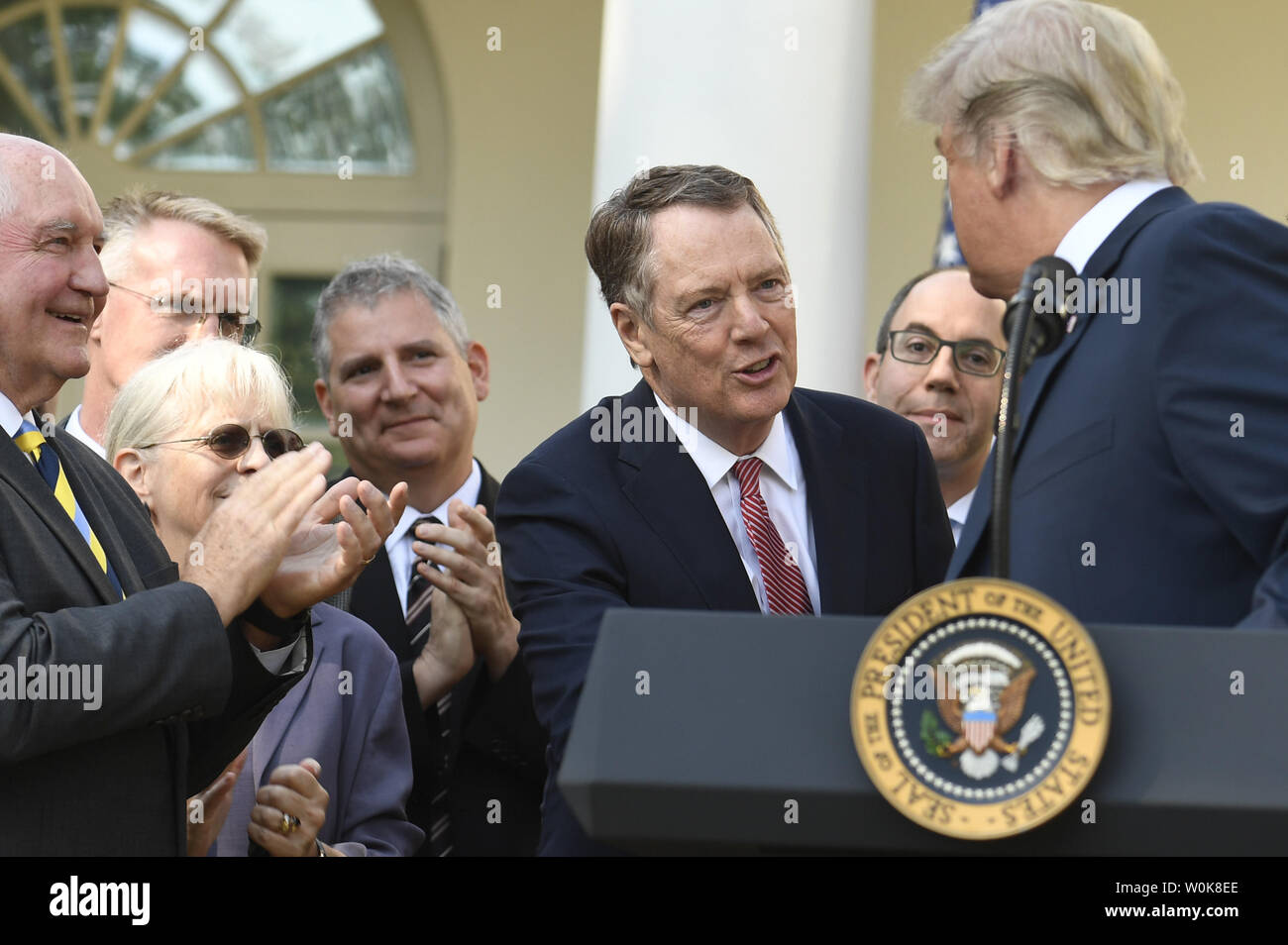 President Donald Trump (R) shakes hands with US Trade Representative Robert Lighthizer, as Agriculture Secretary Sonny Perdue applauds (L), during an announcement on the United States Mexico Canada Agreement (USMCA) in the Rose Garden of the White House, October 1, 2018, in Washington, DC. The trilateral USMCA trade pact will replace the North American Free Trade Agreement (NAFTA) of 1994.           Photo by Mike Theiler/UPI Stock Photo