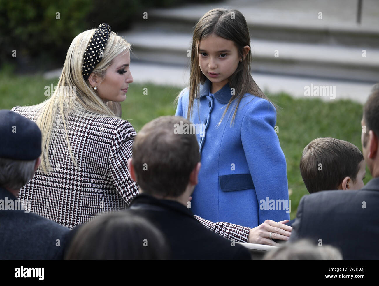 Ivanka Trump (L) and her daughter Arabella Rose Kushner take their seats as  they await President Donald Trump's annual pardoning of the Thanksgiving  turkey, named "Peas", at the White House, November 20,
