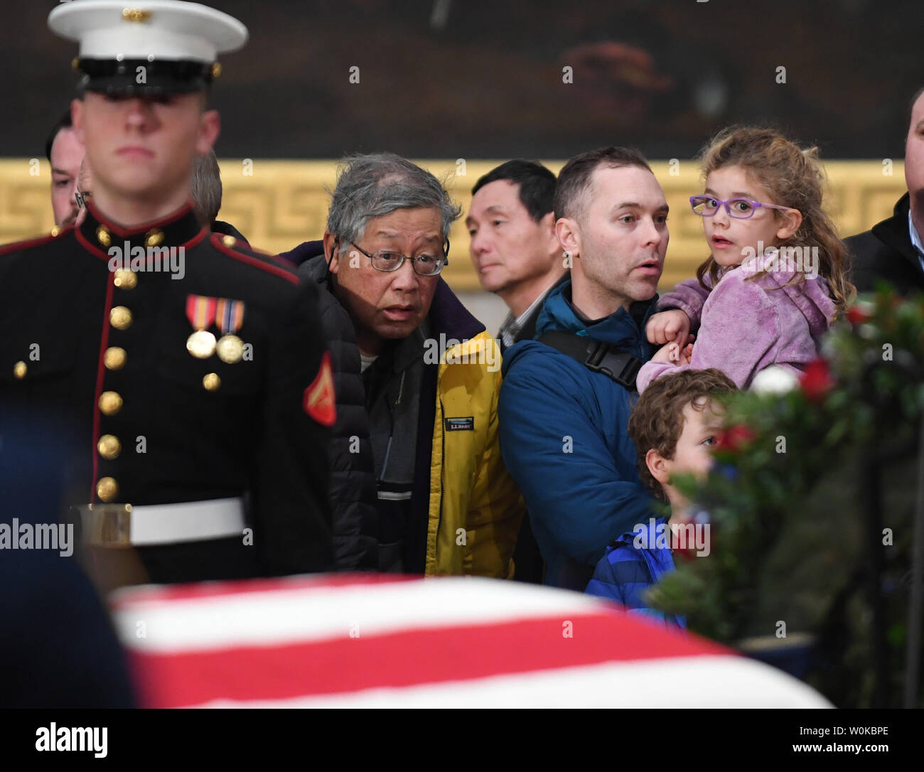 Young and old pay their respects to former President George H. W. Bush as the 41st president lies in state at the U.S. Capitol Rotunda, in Washington, D.C. on December 4, 2018.  There will be a State Funeral at the National Cathedral on Wednesday, December 5, 2018.   Photo by Pat Benic/UPI Stock Photo