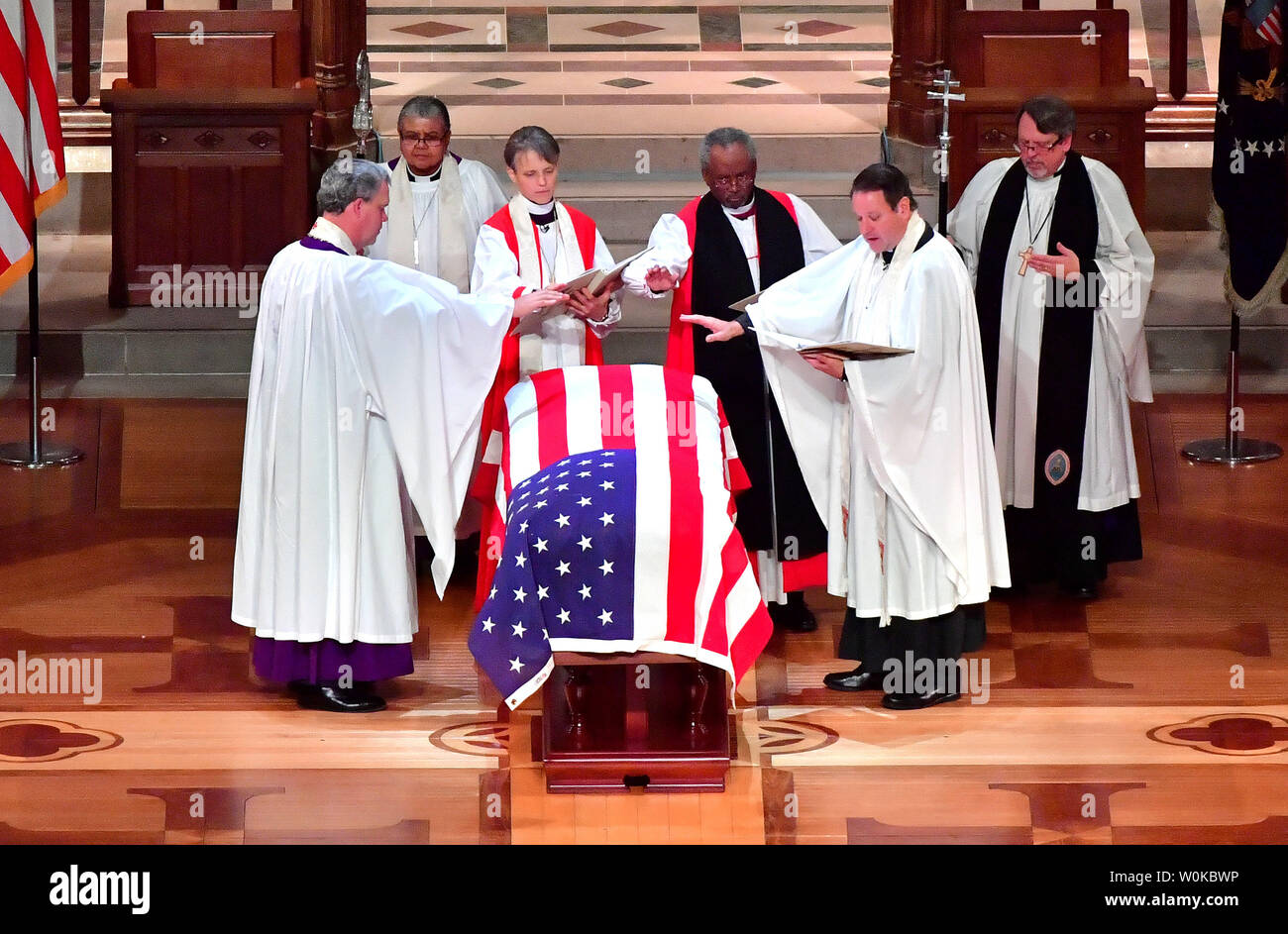 Members of the clergy pray over the casket of President George H.W. Bush during his funeral at the National Cathedral, in Washington D.C. on December 5, 2018. Photo by Kevin Dietsch/UPI Stock Photo