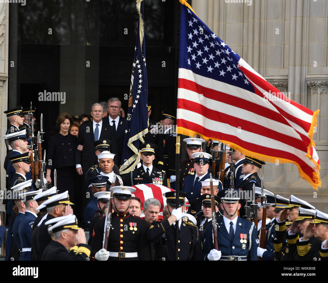 The casket of President George Herbert Walker Bush is followed out of the National Cathedral by sons George W. Bush and Jeb Bush following the funeral of the 41st  President of the United States in Washington D.C. on December 5, 2018.   Photo by Pat Benic/UPI Stock Photo