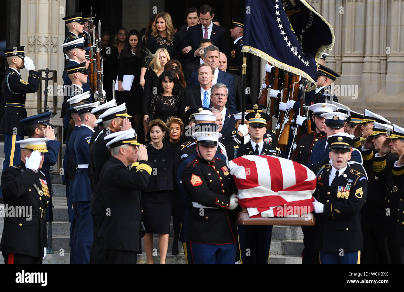 The casket of President George Herbert Walker Bush is followed out of ...