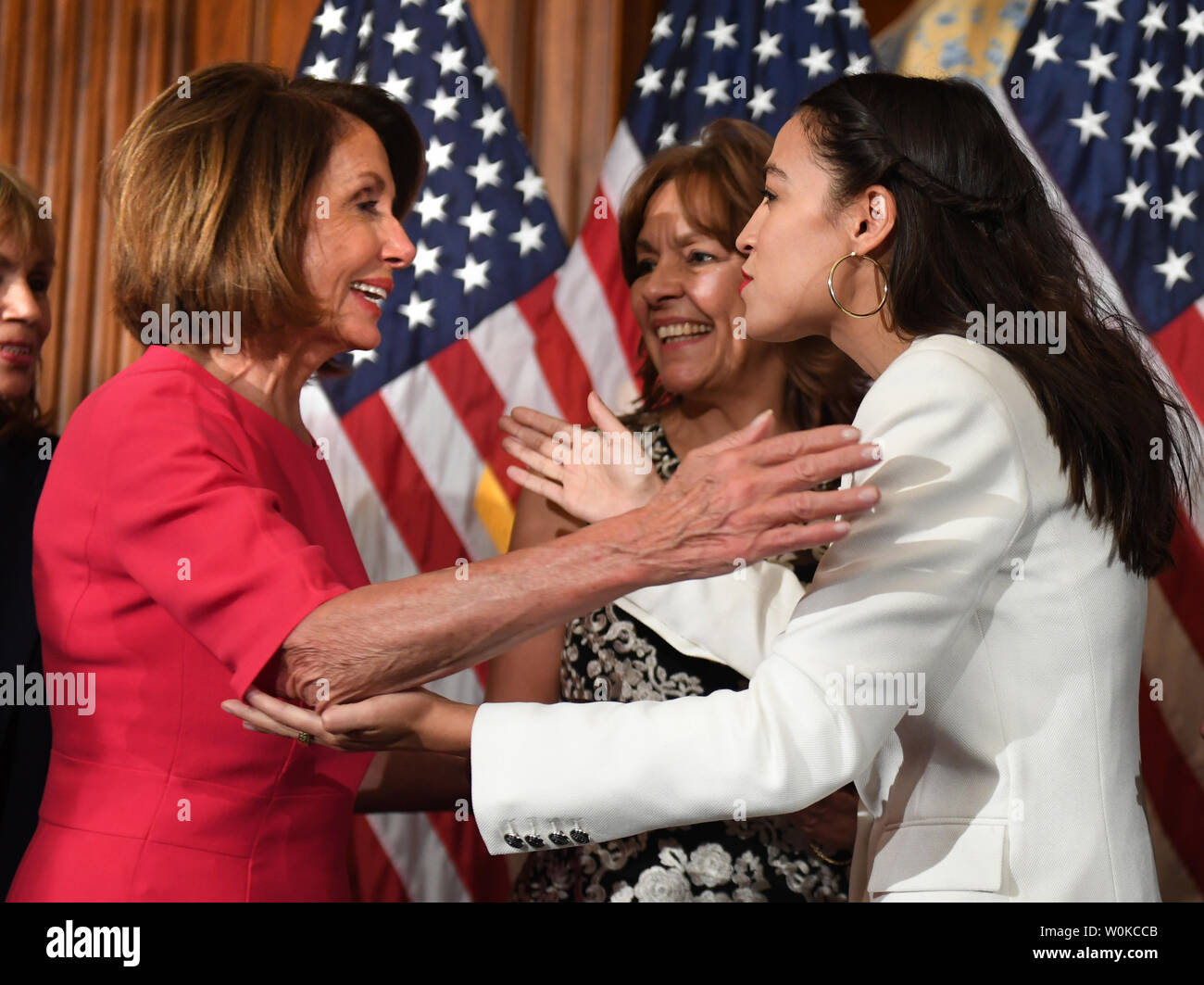 Newly elected Speaker of the House Nancy Pelosi hugs and kisses  Rep. Alexandria Ocasio-Cortez, D-NY, at a mock swearing-in event with family members at the U.S. Capitol in Washington, DC on January 3, 2019. Pelosi became the first official to return to that position since Sam Rayburn in 1955.  Ocasio-Cortez became the youngest woman ever in Congress at age 29.     Photo by Pat Benic/UPI Stock Photo