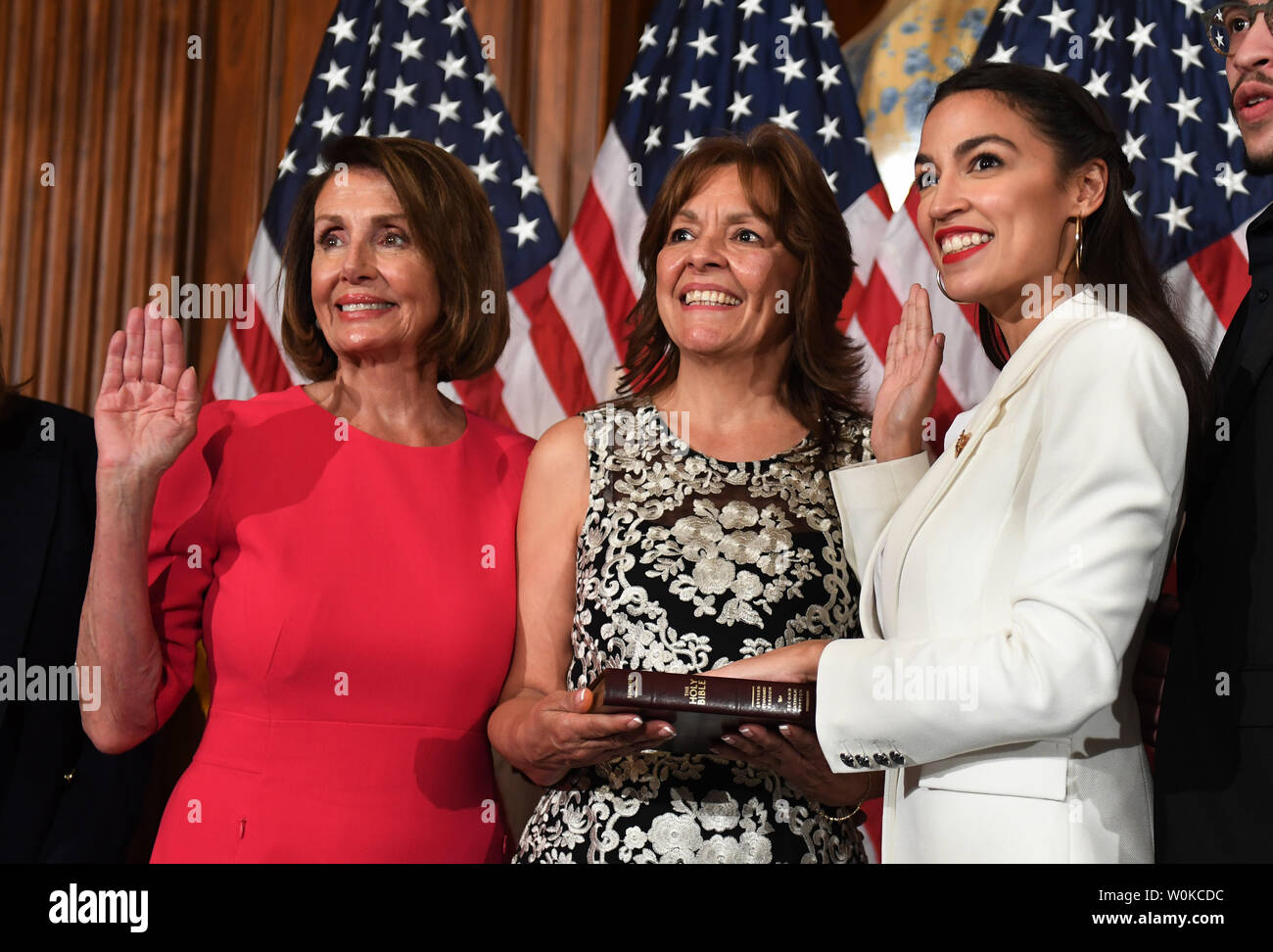 Newly elected Speaker of the House Nancy Pelosi swears in Rep. Alexandria Ocasio-Cortez, D-NY, (R) at a mock event with family members at the U.S. Capitol in Washington, DC on January 3, 2019. Pelosi, 52nd Speaker of the House, became the first official to return to that position since Sam Rayburn in 1955.  Ocasio-Cortez is the youngest woman ever in Congress at age 29.     Photo by Pat Benic/UPI Stock Photo