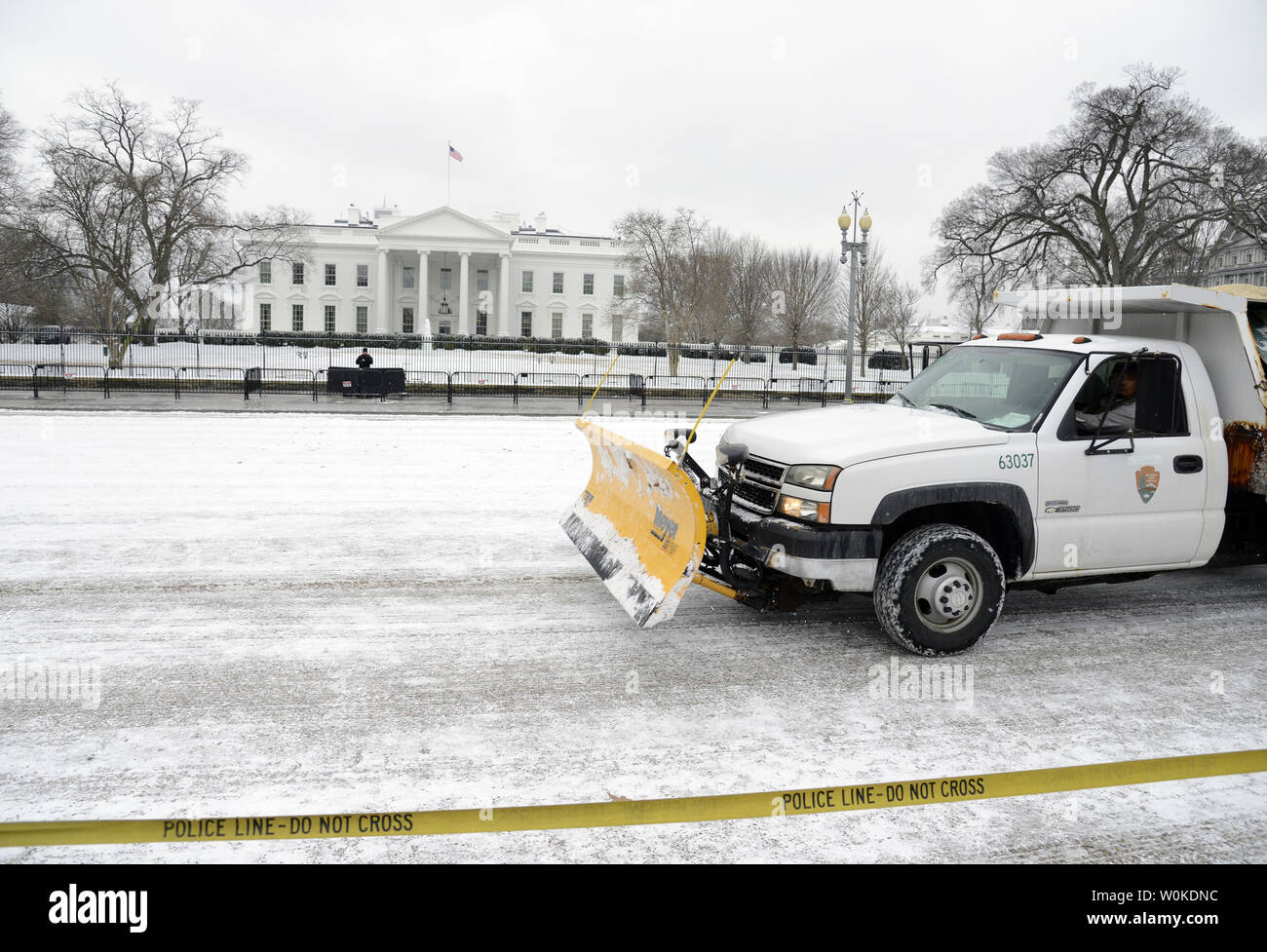 A snow plow moves along Pennsylvania Aveune in front of the White House after a dusting of snow, Washington, DC, February 1, 2019. A polar vortex across much of North Central and Eastern United States is blamed for at least 21 deaths.   Photo by Mike Theiler/UPI Stock Photo