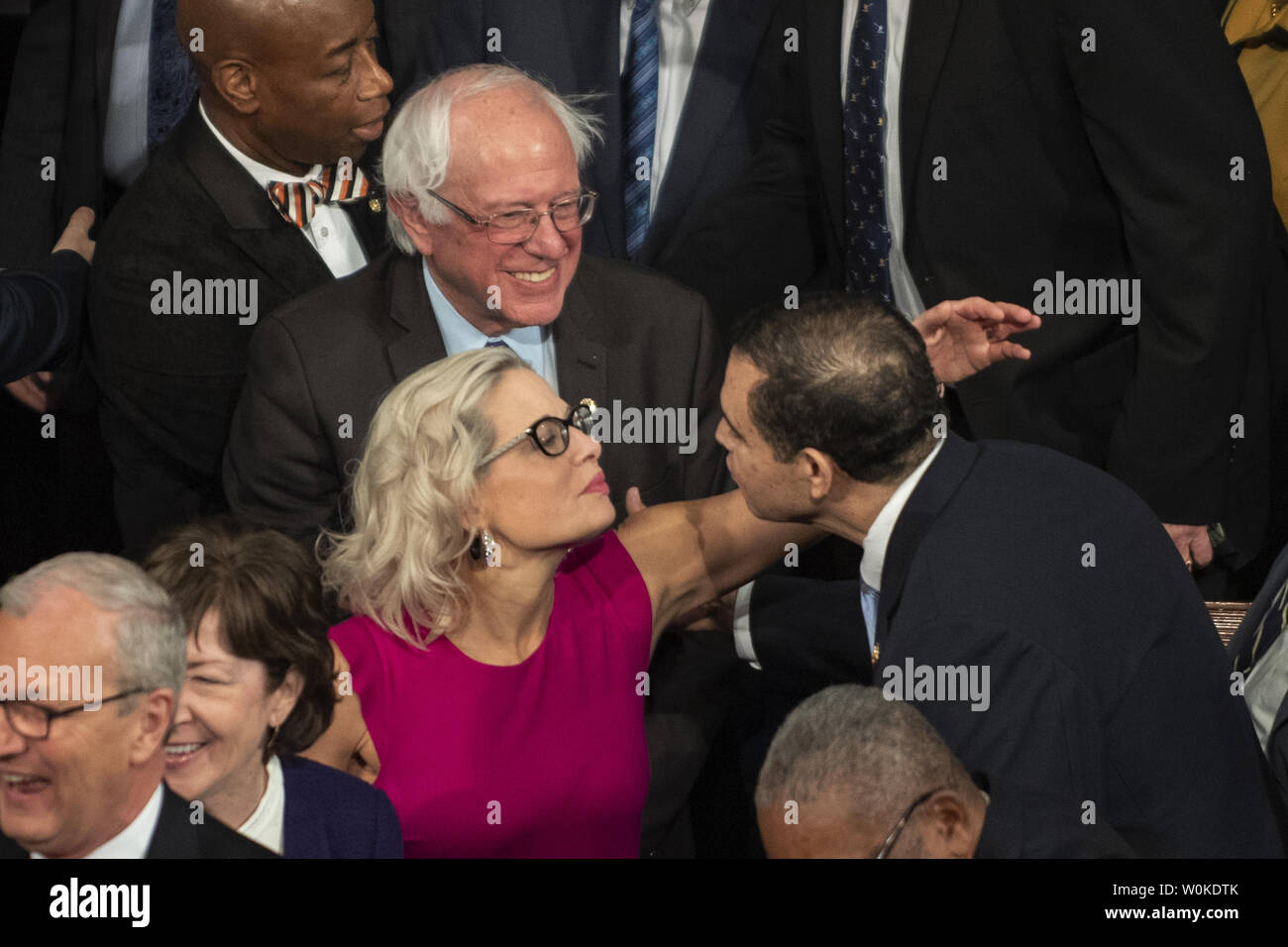 Senator Kyrsten Sinema, D-Ariz, offeres a hug as she arrives with Senator  Bernie Sanders and other senators to hear President Donald Trump deliver  his State of the Union address to a joint