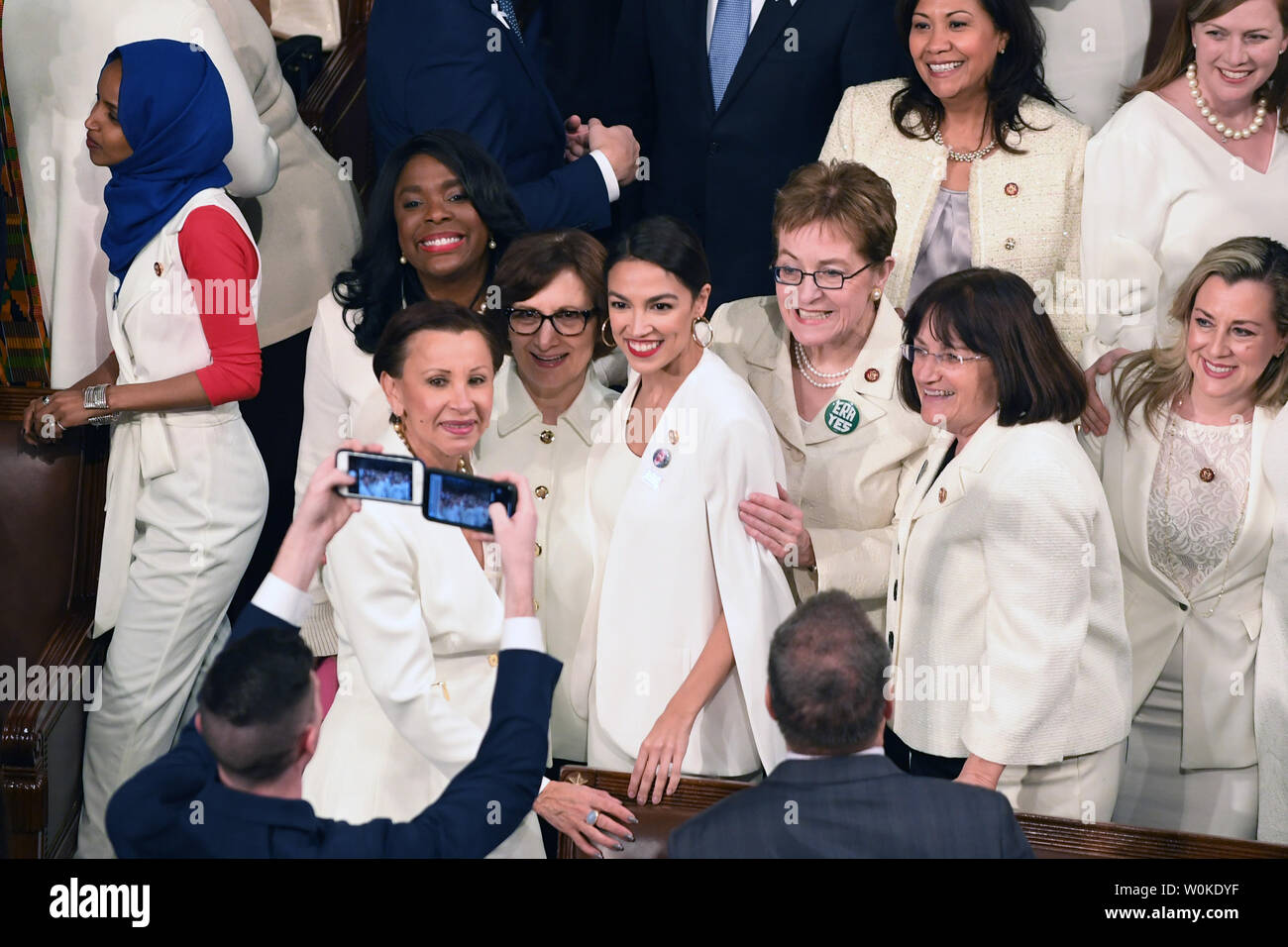 Alexandria Ocasio-Cortez (D-NY) (C) joins other congresswomen wearing white in honor of women's suffrage, pose for photos before President Donald Trump delivers his State of the Union address to a joint session of Congress in the House Chamber of the U.S. Capitol in Washington, DC on February 5, 2019.    Photo by Pat Benic/UPI Stock Photo