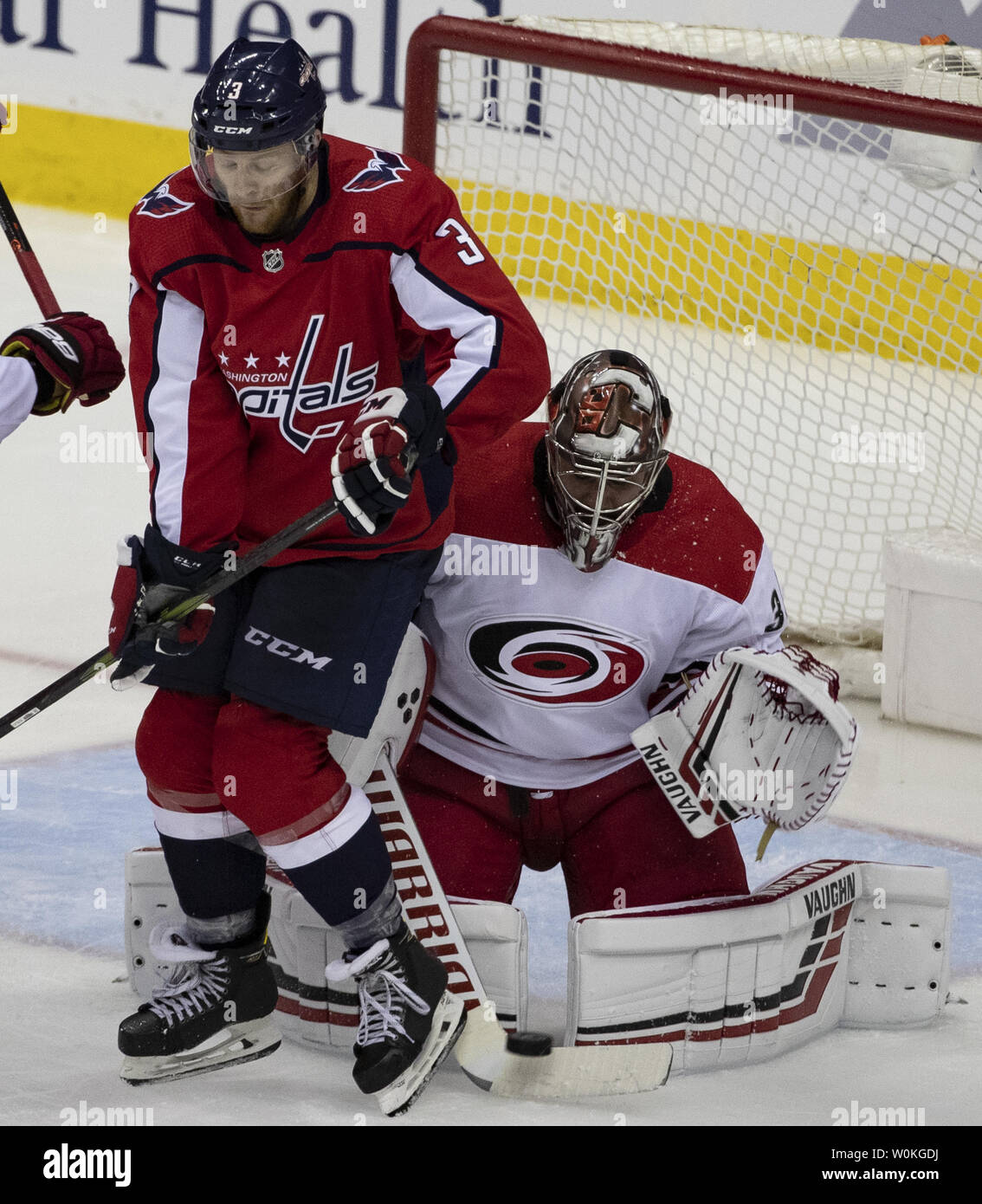 Washington Capitals defenseman Nick Jensen (3) screens Carolina Hurricanes goaltender Petr Mrazek (34) on a shot by Capitals right wing Tom Wilson (43) during the third period at Capital One Arena in Washington, D.C. on April 13, 2019. The Washington Capitals lead the best of seven series with one win. Photo by Alex Edelman/UPI Stock Photo
