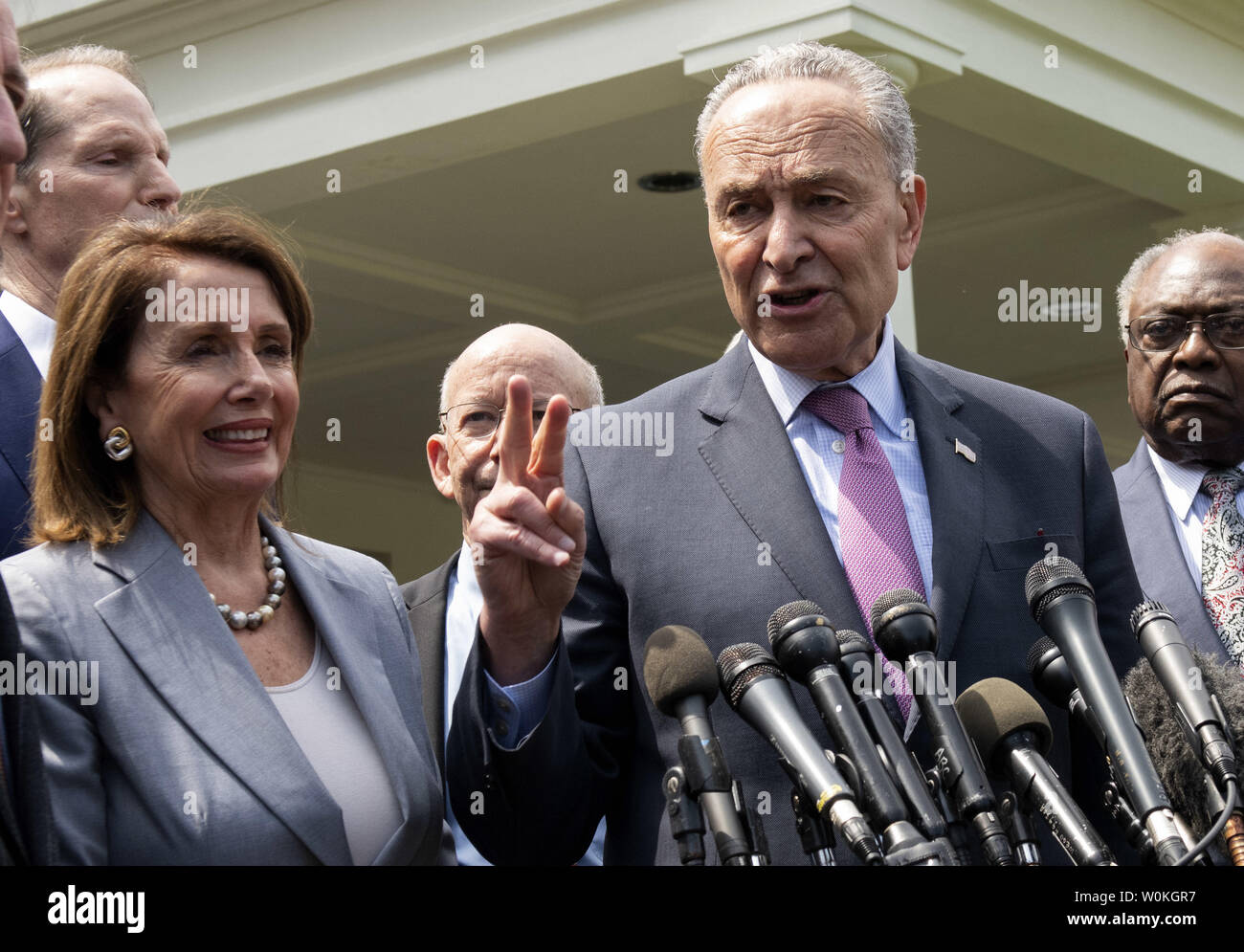 Senate Minority Leader Chuch Schumer holds up two fingers as he discusses a two million dollar infrastructure bill with reporters after meeting President Donald Trump at the White House in Washington on April 30, 2019. Speaker of the House Nancy Pelosi is at left.  Democrat congressional leaders met with Trump on a possible two trillion dollar infrastructure legislation.    Photo by Pat Benic/UPI Stock Photo