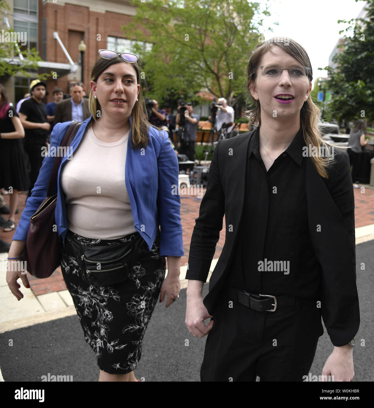 Former US Army intelligence analyst Chelsea Manning (R) walks with her