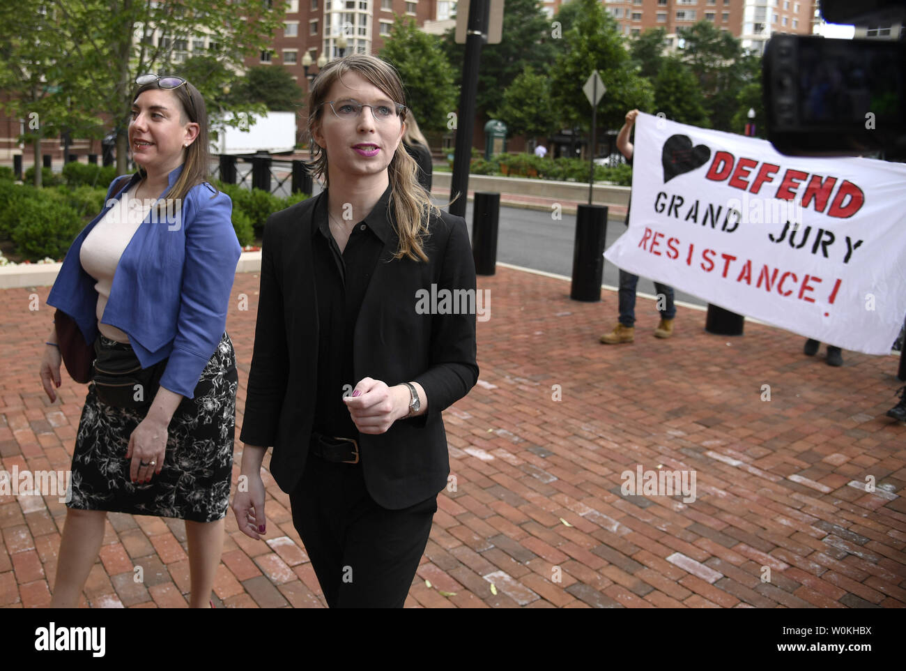Former US Army intelligence analyst Chelsea Manning (R) walks with her