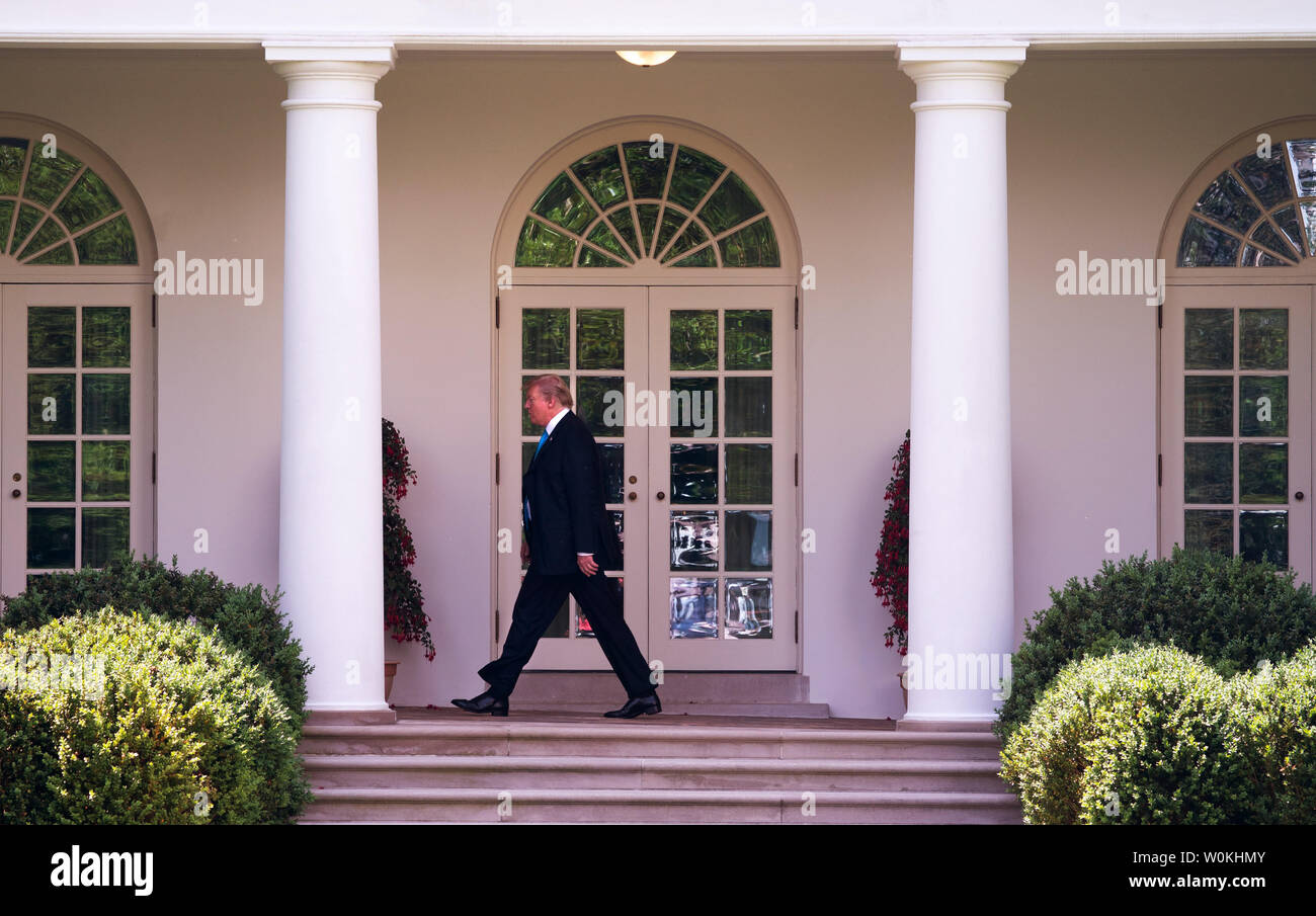 President Donald Trump walks to the Oval Office after he and First Lady ...