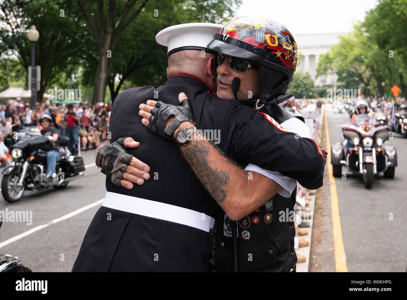 A motorcyclist hugs retired USMC SSGT Tim Chambers during Rolling Thunder,  the annual Memorial Day weekend motorcycle rally for veterans, prisoners of  war and service members that draws hundreds of thousands of