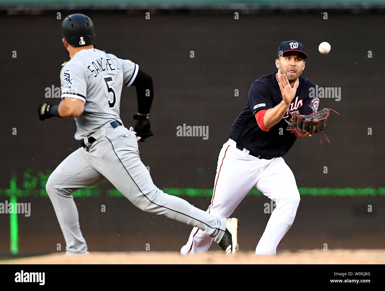 Washington Nationals second baseman Brian Dozier 9 tags out San Francisco Giants Steven Duggar as he attempted to steal second at Nationals Park in Washington D.C. on April 18 2019. Photo by