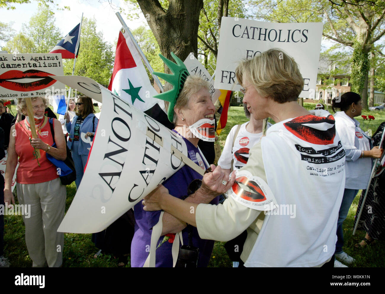 Catholics for a Free Choice activist Carol Wall (L) from Boston greets Katie Early, North Caroline before march to the Vatican Embassy in Washington, April 24, 2004. (UPI Photo/Yuri Gripas) Stock Photo