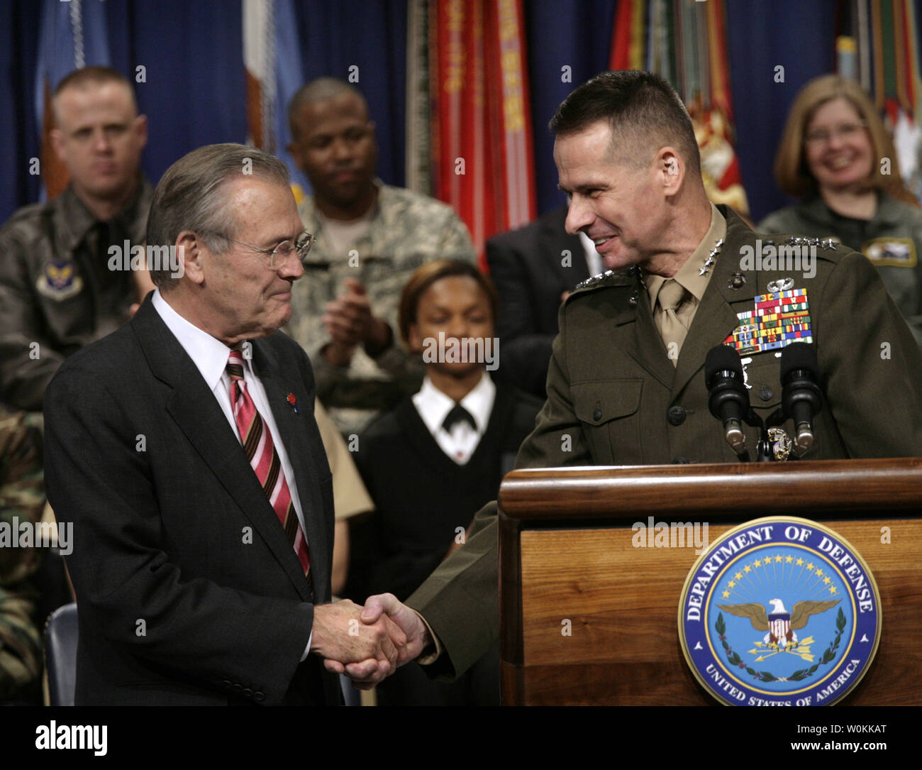 U.S. Defense Secretary Donald Rumsfeld, left, shakes hands with General Peter Pace, Chairman of the Joint Chiefs of Staff, at the Pentagon Town Hall meeting in Washington, December 15, 2005. (UPI Photo/Yuri Gripas) Stock Photo