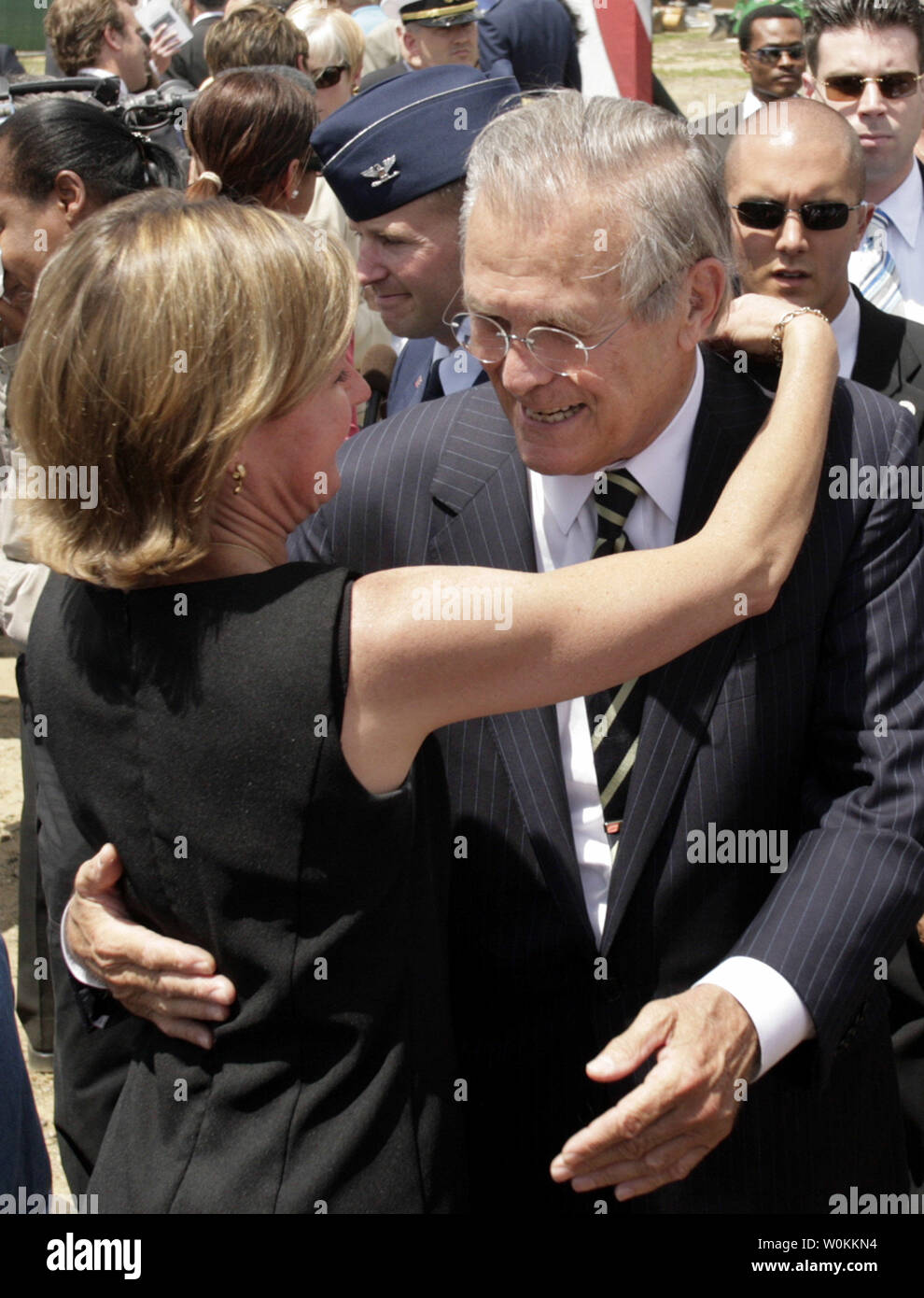 U.S. Defense Secretary Donald H. Rumsfeld (R) hugs with family member of victims who died in the September 11 attack on the Pentagon after a Memorial ground-breaking ceremony on June 15, 2006. The Pentagon Memorial will commemorate the 184 innocent lives lost in the Pentagon and on American Airlines Flight 77 on September 11, 2001. (UPI Photo/Yuri Gripas) Stock Photo